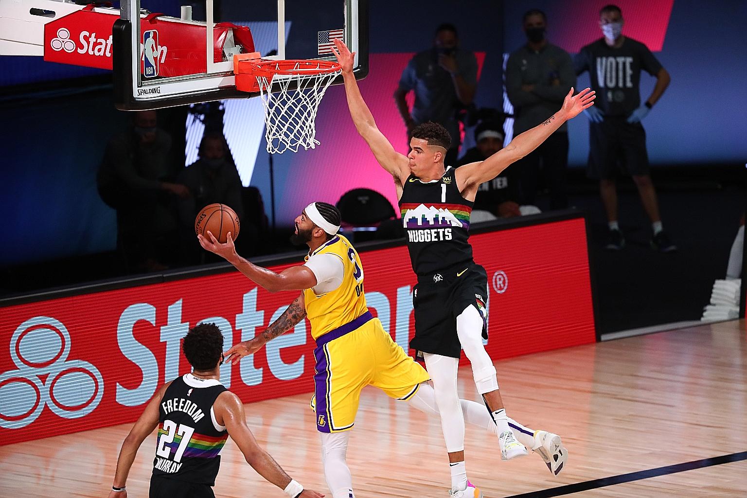 Los Angeles Lakers' Anthony Davis shooting past Denver Nuggets' Michael Porter Jr during Game 4 of the NBA's Western Conference Finals series at the AdventHealth Arena. Davis combined with LeBron James for 60 points.