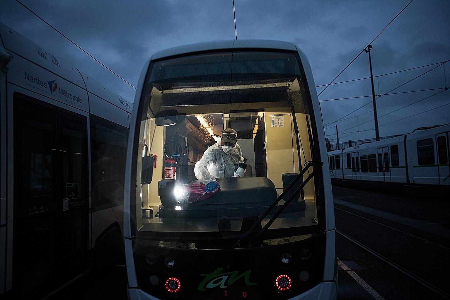 FRANCE: An employee disinfecting a tramway in Nantes in April. France has recorded more than 31,500 deaths and nearly 500,000 cases of infection, the second highest in Europe after Spain. ITALY: Masks bearing the names of medical staff are pinned to 