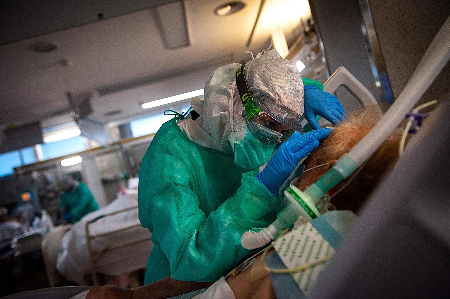 FRANCE: An employee disinfecting a tramway in Nantes in April. France has recorded more than 31,500 deaths and nearly 500,000 cases of infection, the second highest in Europe after Spain. ITALY: Masks bearing the names of medical staff are pinned to 