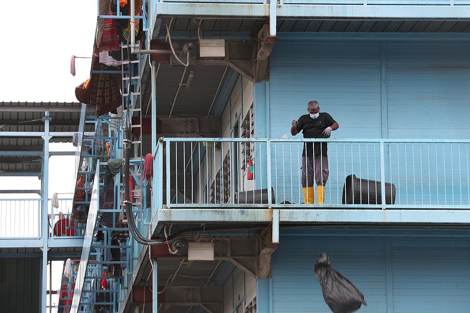 A worker throwing the trash at Tuas View Dormitory last month. All migrant worker dormitories were declared to be clear of Covid-19 on Aug 20, including standalone blocks in purpose-built dormitories that served as isolation or quarantine facilities.