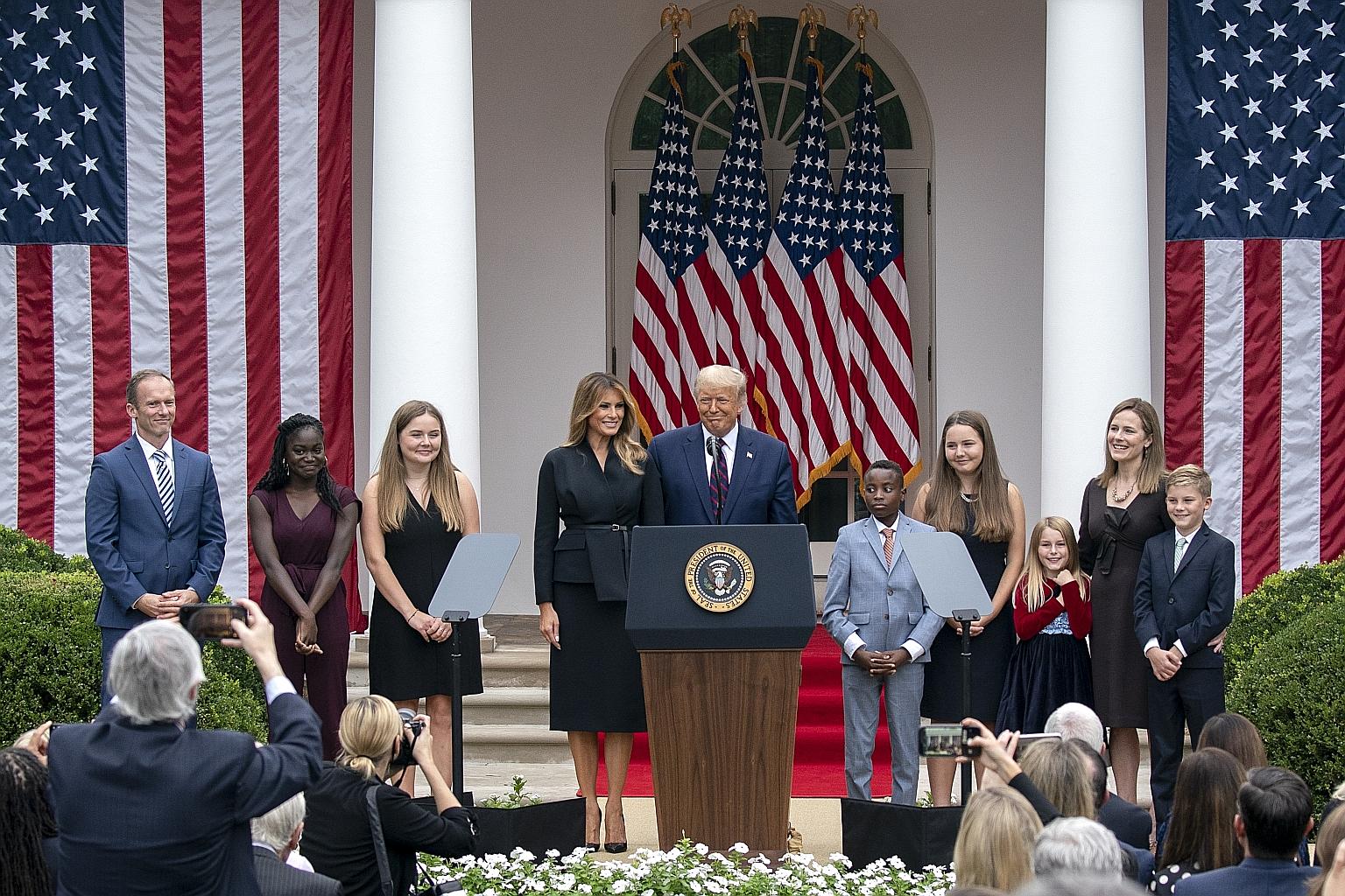 US President Donald Trump and his wife Melania with Supreme Court Justice nominee Amy Coney Barrett (second from right), and some of her family members on stage, following a ceremony in the Rose Garden of the White House in Washington last Saturday. 
