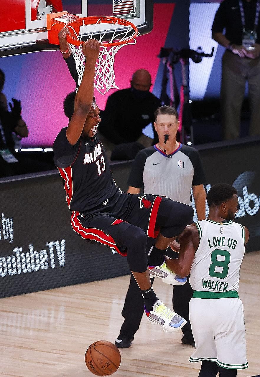 Miami's Bam Adebayo dunking the ball over Boston's Kemba Walker in Game Six of the Eastern Conference Finals on Sunday. He had a career-high 32 points and 14 rebounds in the 125-113 win, which gave his team a 4-2 series success and a place in the NBA