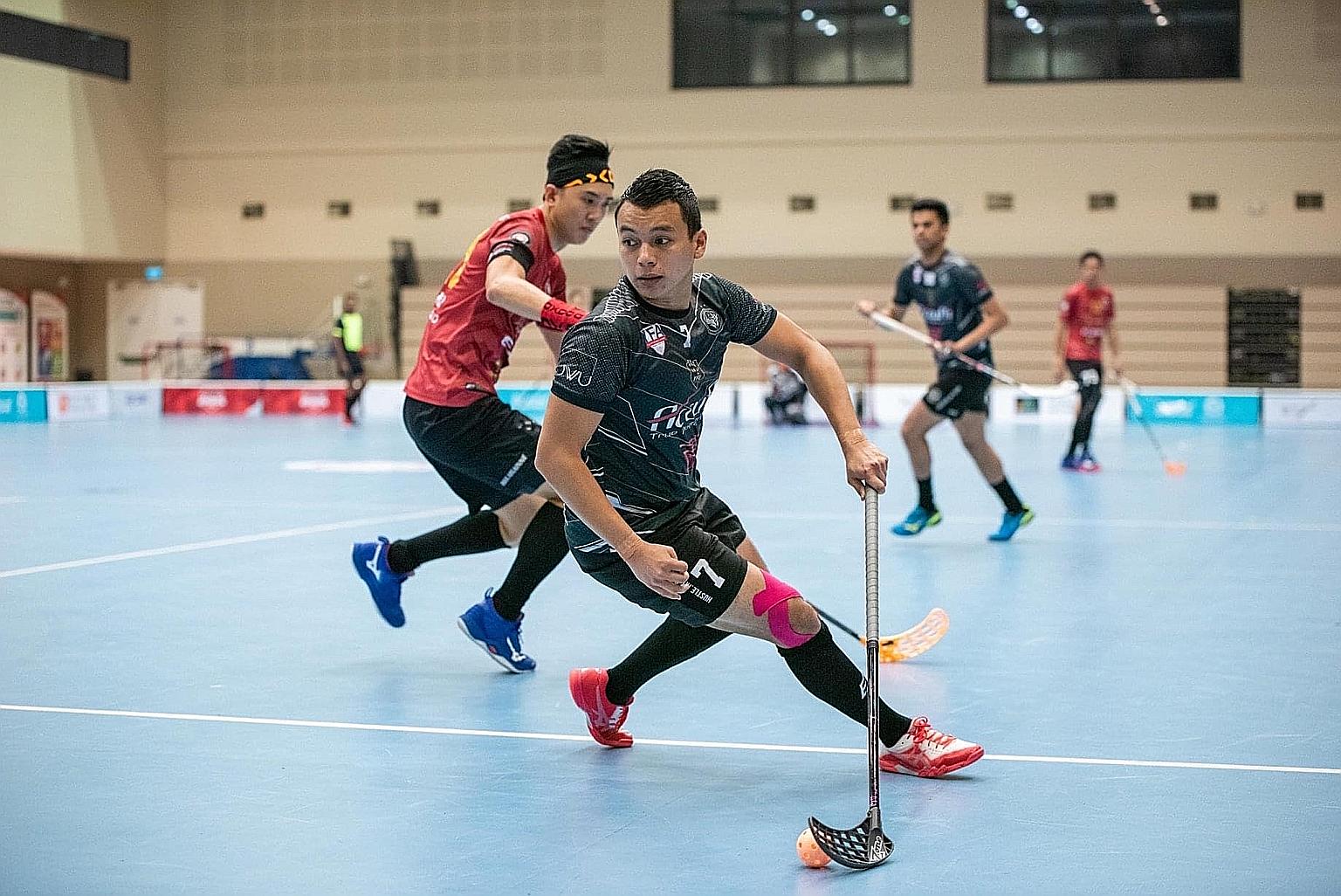 National floorball captain and Black Wondersticks player Syazni Ramlee in action during the final of the ActiveSG-SFA Floorball Premier League play-offs last September at Our Tampines Hub. PHOTO COURTESY OF SINGAPORE FLOORBALL ASSOCIATION