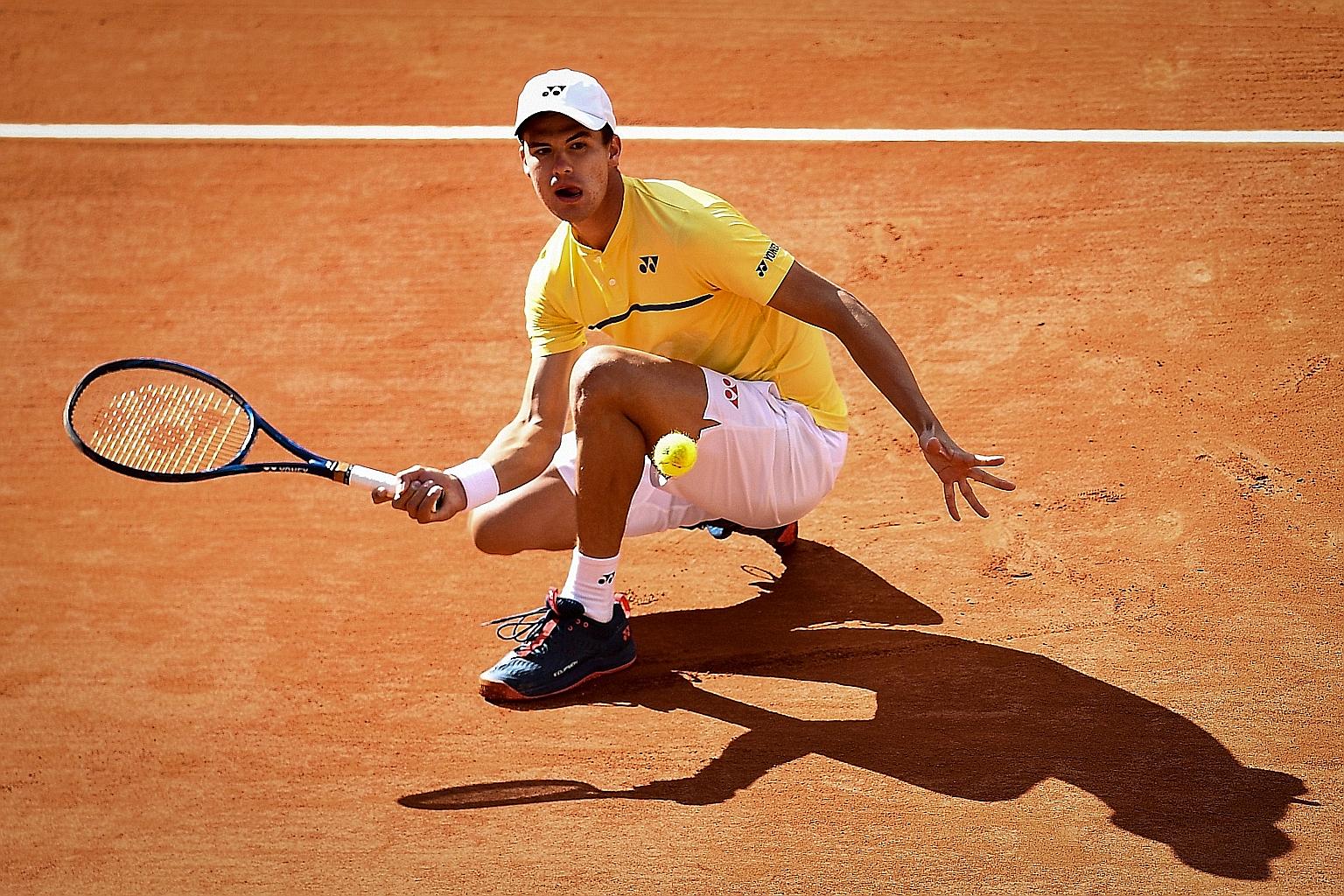 Germany's Daniel Altmaier returning the ball to Italy's Matteo Berrettini during their third-round match yesterday. The qualifier, ranked 186th in the world, bundled out Italian world No. 8 Matteo Berrettini 6-2, 7-6 (7-5), 6-4.