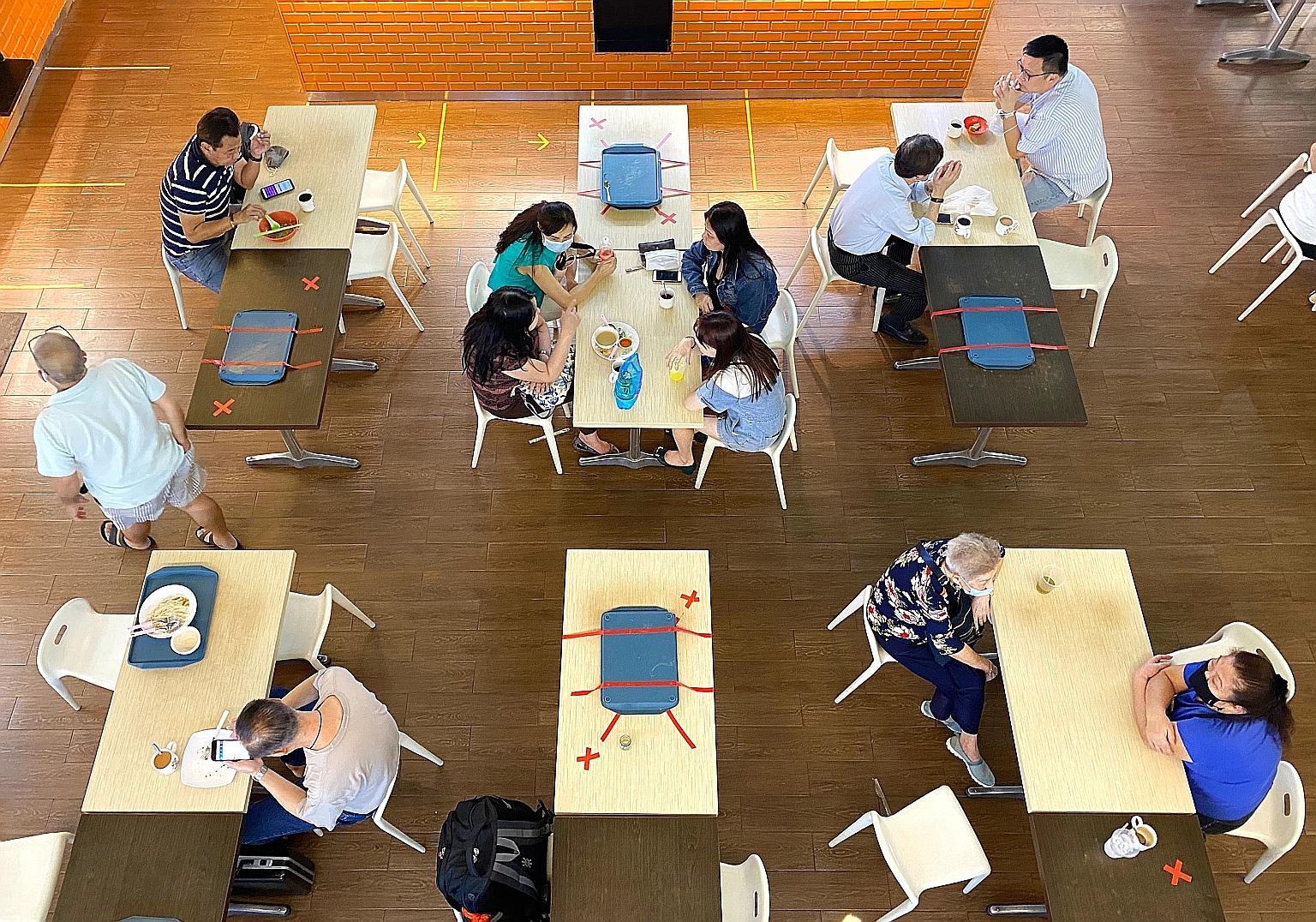 Diners at People's Park Centre yesterday. Letting larger groups gather would allow bigger families or groups of friends to meet and have meals together, Health Minister Gan Kim Yong said in response to questions from several MPs on the loosening of C