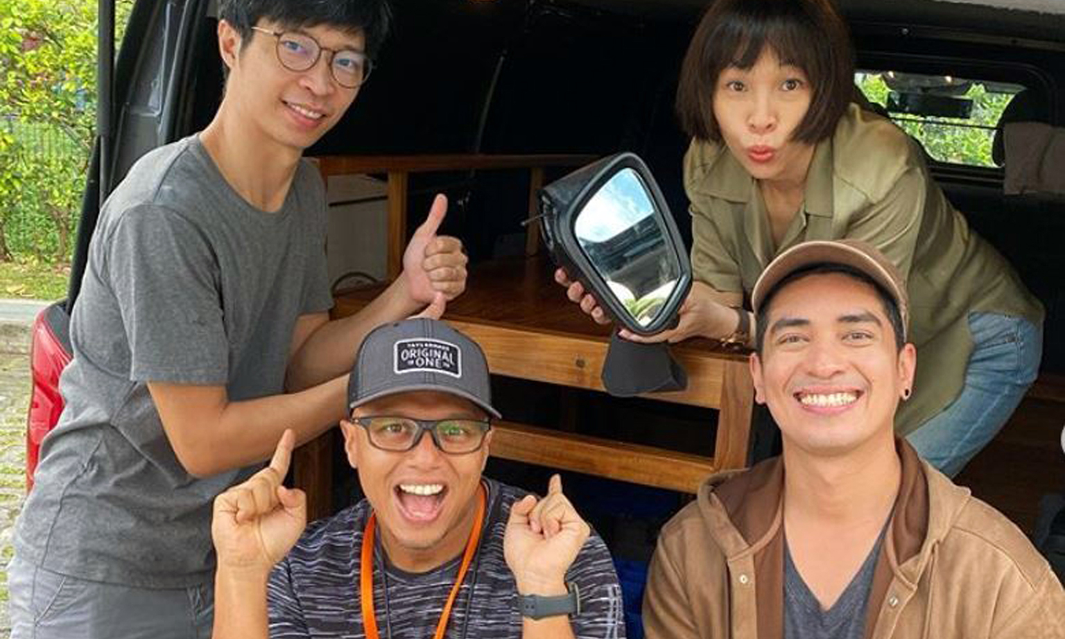 Kiss92 radio DJ Maddy Barber, seen here with (clockwise from top left) Mr Mei Jie Xiang, who traded the handmade teak wood desk set for her broken side-view mirror, and her colleagues Divian Nair and Andre Hoeden. Mr Hoeden is also a presenter and ex