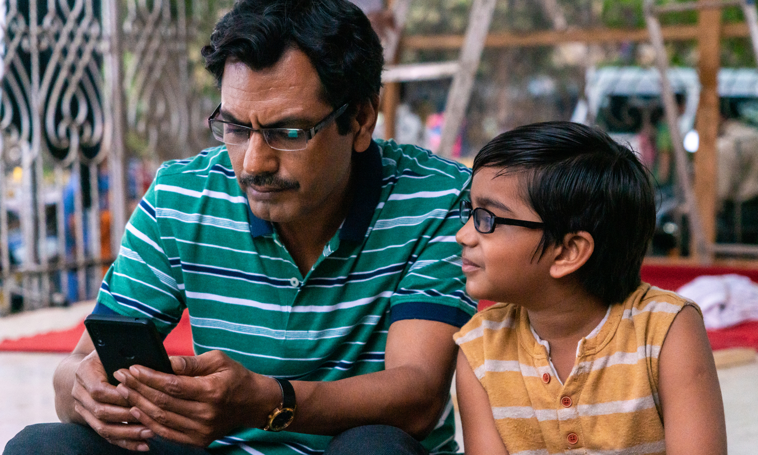 Nawazuddin Siddiqui  (left) plays Ayyan Mani and Aakshath Das (right) as Adi Mani in Serious Men.