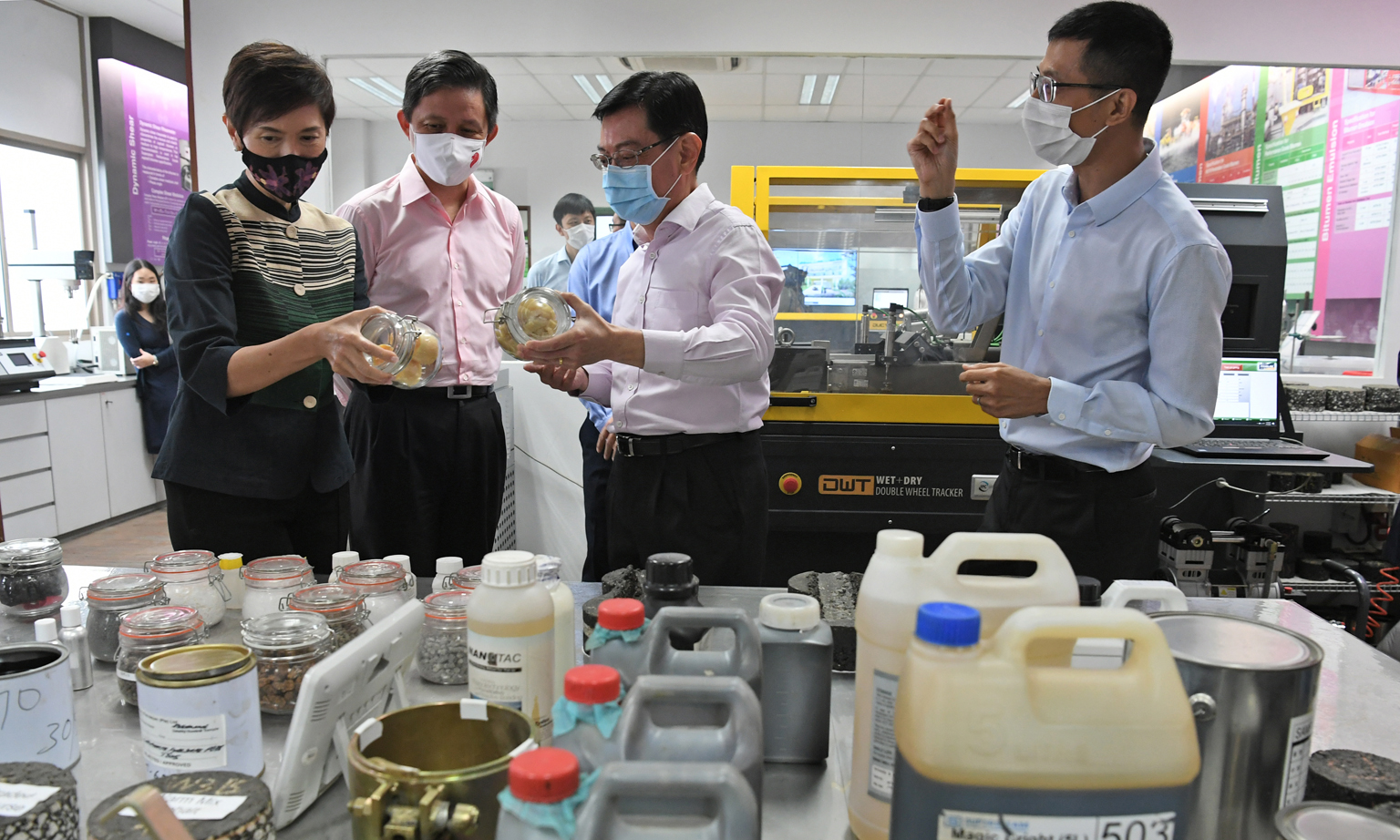 Deputy Prime Minister Heng Swee Keat at the Samwoh Research and Development Centre with (from left) Minister for Manpower Josephine Teo, Minister for Trade and Industry Chan Chun Sing, and Dr Kelvin Lee, Samwoh's senior technical manager. 