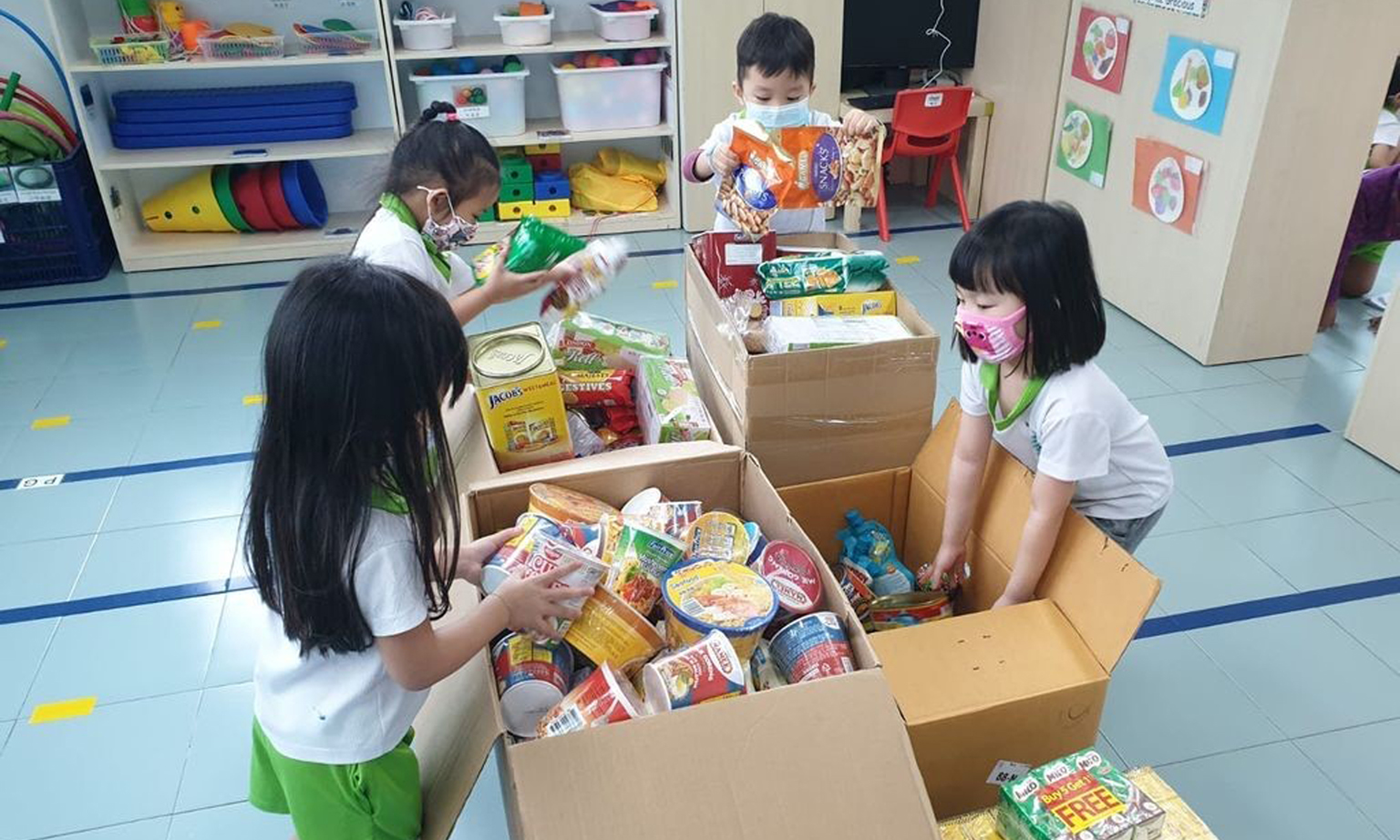 Children from Greenland Childcare @ Punggol Drive packing food supplies for migrant workers staying in dormitories. The supplies were delivered with the help of SG Accident Help Centre, a non-profit organisation. 