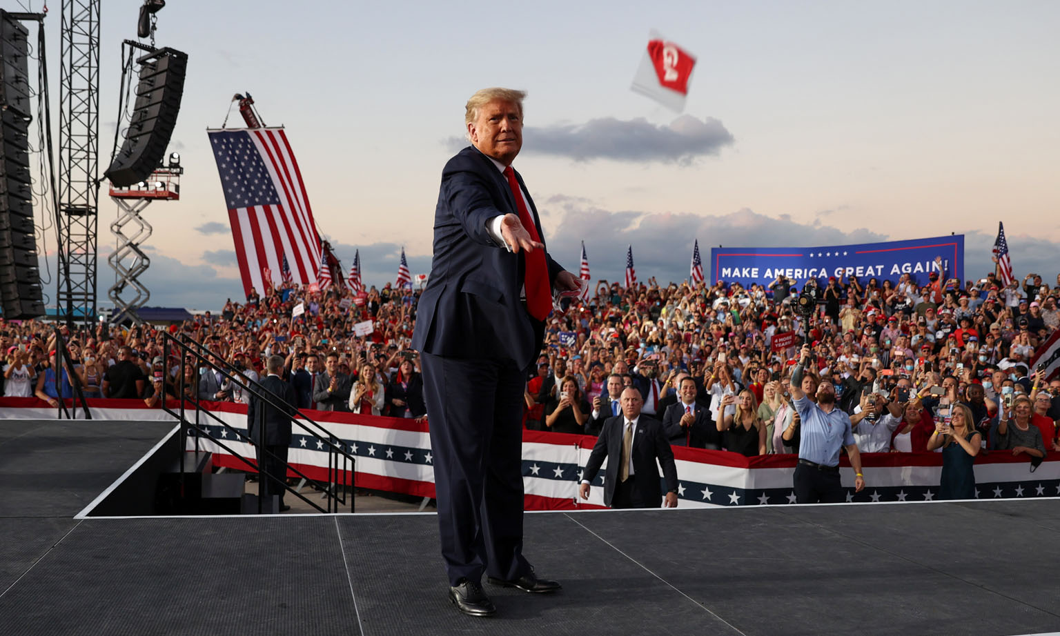 US President Donald Trump tossing out face masks to the crowd at a campaign rally, his first since he announced his Covid-19 diagnosis, at an airport in Sanford, Florida, on Monday. The event is the first of six planned for this week. He is also expected 