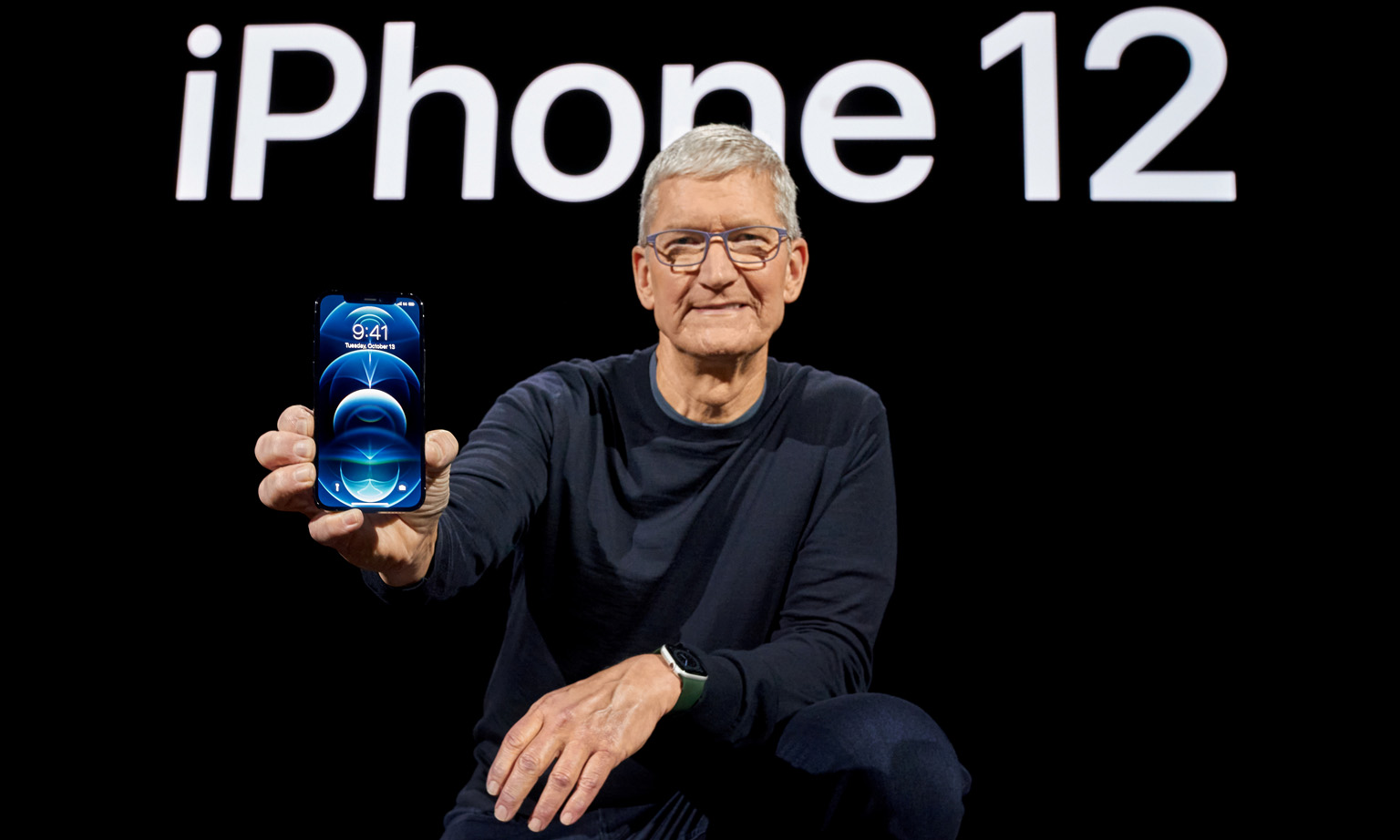 Apple chief executive Tim Cook with one of the brand's new 5G smartphones, the iPhone 12 Pro.