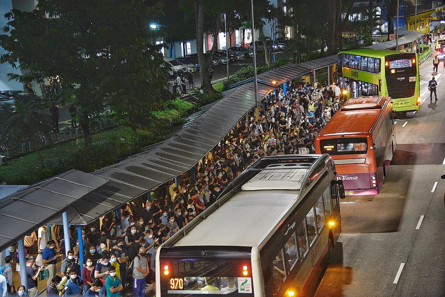 Crowds gathered at the bus stop outside Queenstown MRT station on Wednesday night after a disruption that affected three lines. SMRT said it is working with the Land Transport Authority to conduct a full investigation into the "premature failure" of