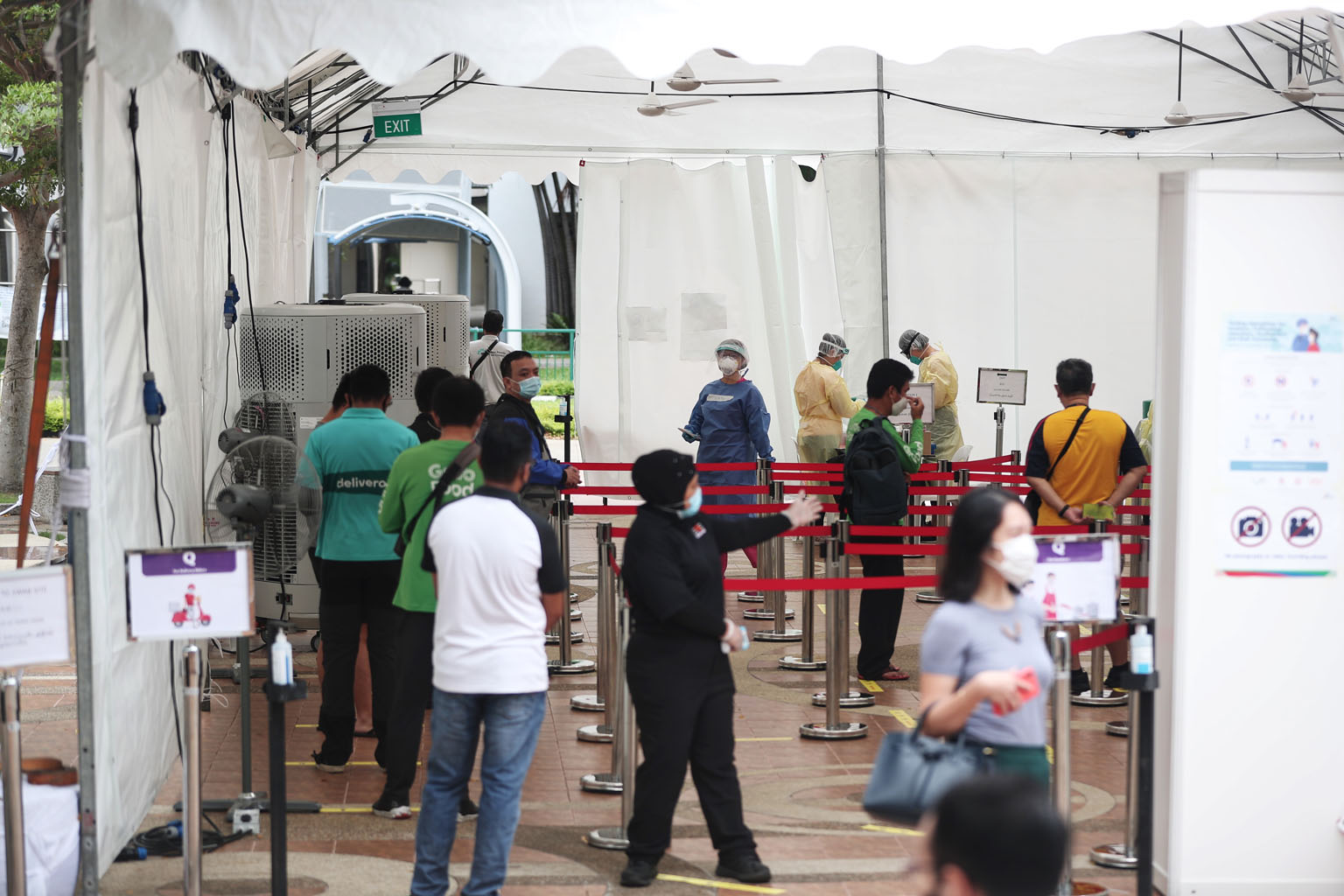 Employees and stallholders at hawker centres and coffee shops, as well as food delivery riders, queueing to be tested for Covid-19 in Marine Parade last month in a pilot swab-testing initiative.