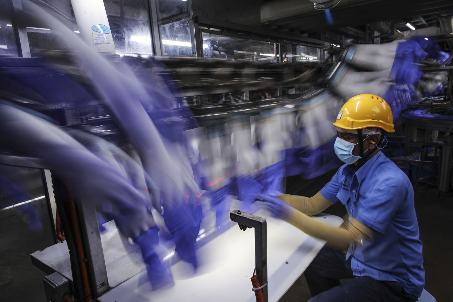 A worker inspecting gloves at Top Glove's factory in Setia Alam, Selangor. Valued at nearly $25 billion, Top Glove is close to overtaking Malayan Banking as the biggest stock on the FTSE Bursa Malaysia KLCI Index, and fellow glove maker Hartalega is