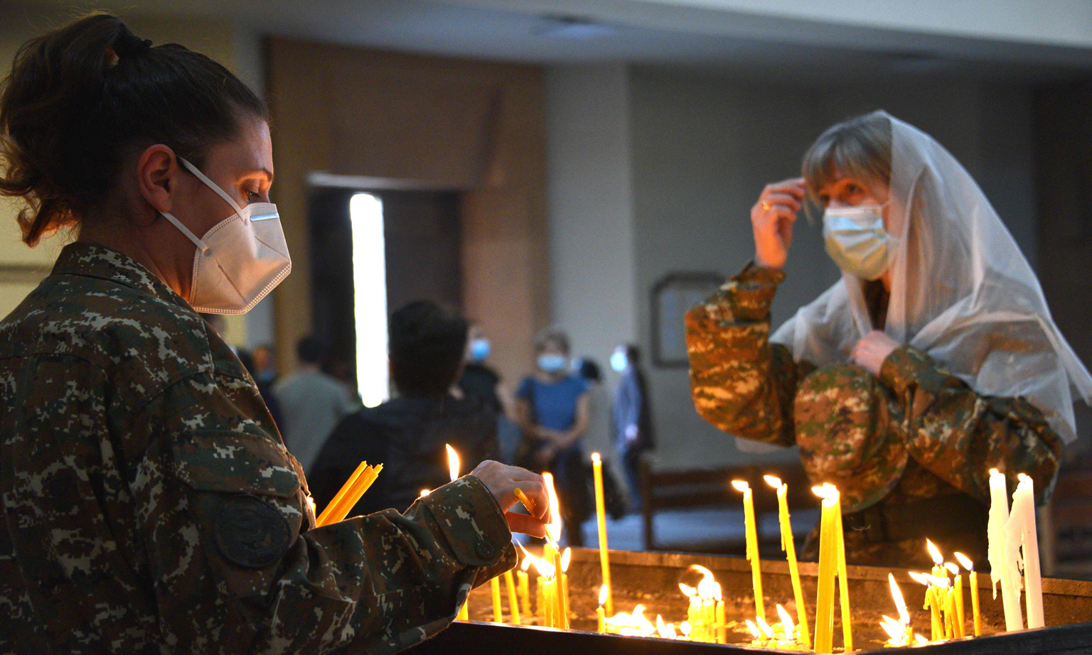 Armenians lighting candles in a church in Yerevan last Saturday for their countrymen killed during fighting over the breakaway region of Nagorno-Karabakh. The truce agreed to last Saturday came into force at midnight after a week-old Russian-brokered