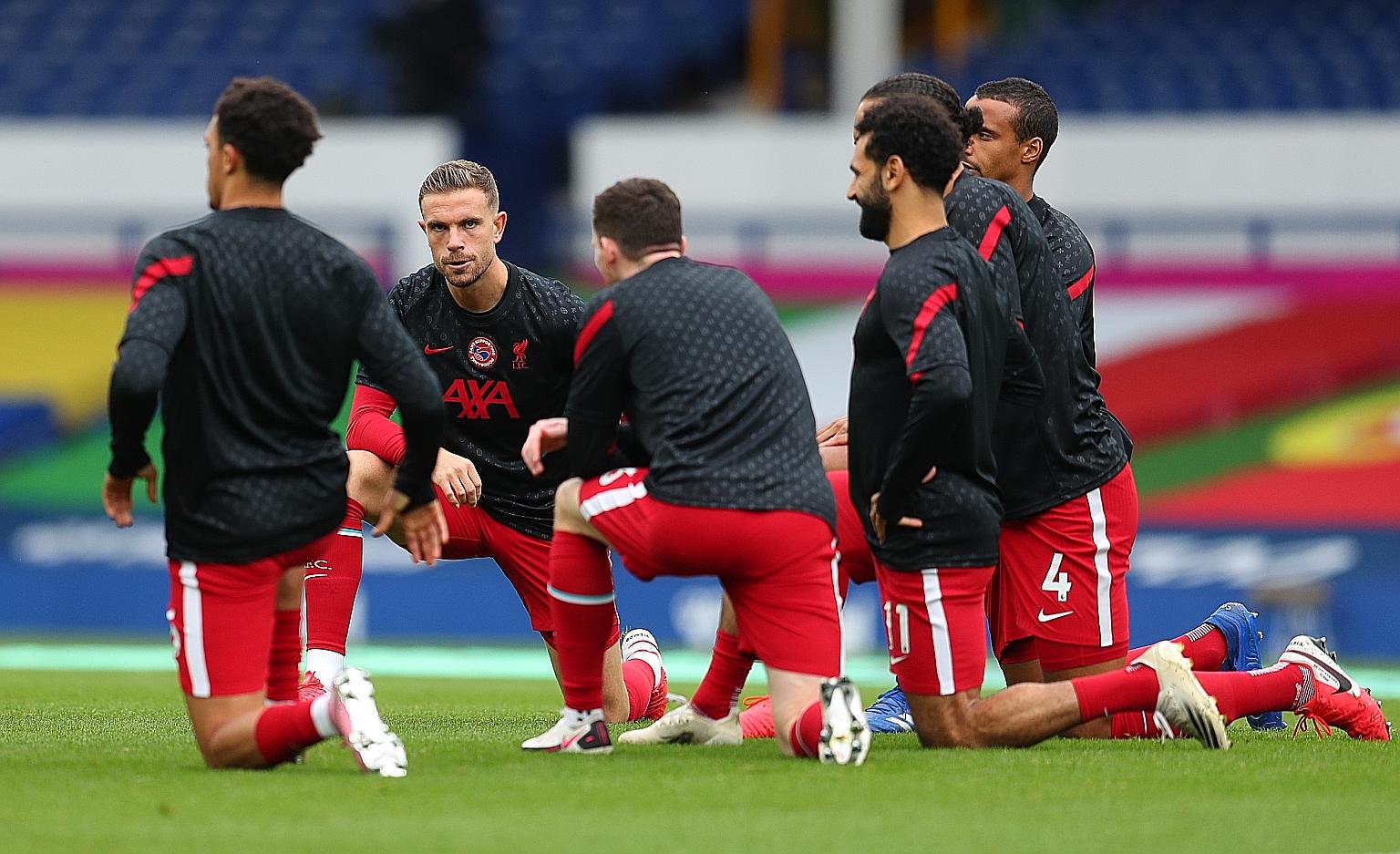 Liverpool captain Jordan Henderson (second from left), said the team will attempt to do the "ridiculous" in drawing a "positive" from the long-term injury to Virgil van Dijk, by winning games in his absence. PHOTO: REUTERS