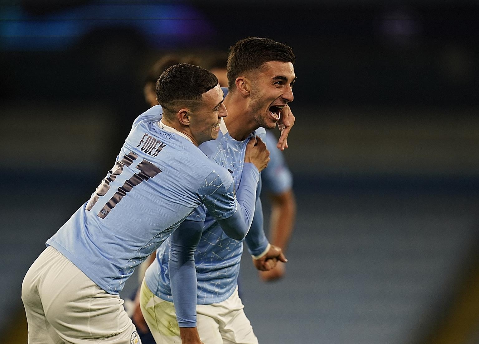 Ferran Torres celebrating with Phil Foden after sealing City's 3-1 win over Porto in Wednesday's Champions League game at the Etihad Stadium. PHOTO: REUTERS