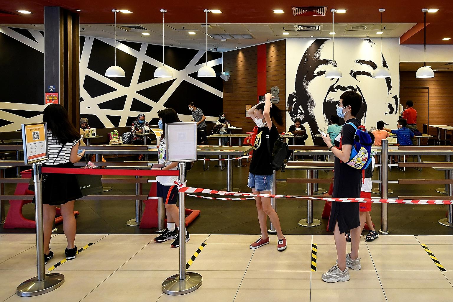 People queueing to enter the McDonald's outlet at Tampines Mall yesterday. There were no new Covid-19 patients in the community yesterday. ST PHOTO: LIM YAOHUI
