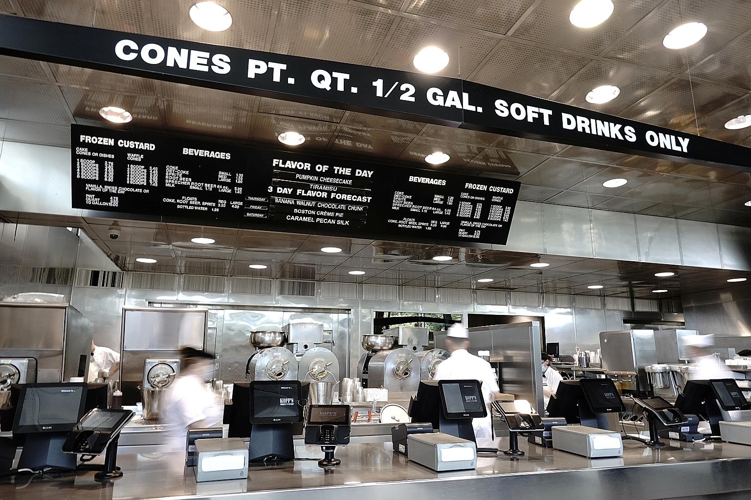 Workers in masks preparing takeaway orders at a Kopp's Frozen Custard outlet in Greenfield, Wisconsin, on Wednesday. Daily case counts in the Midwest hit a record on Monday with over 27,000 new infections reported.