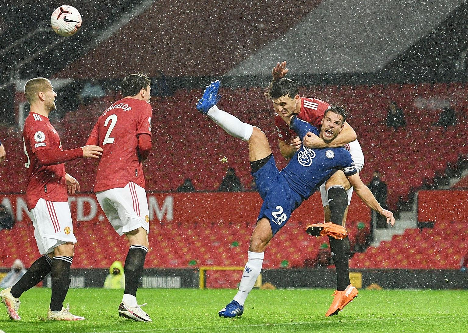Manchester United captain Harry Maguire hauling Chelsea defender Cesar Azpilicueta to the ground in the first half. The VAR checked the incident and found there was no clear and obvious error. PHOTO: REUTERS