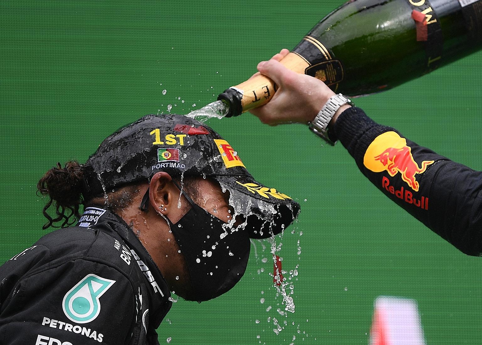 Mercedes' Lewis Hamilton celebrating with champagne on the podium after winning the Portuguese Grand Prix last weekend for a record 92nd victory in Formula One.