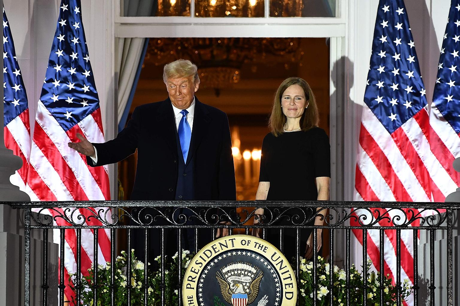 US President Donald Trump with Justice Amy Coney Barrett on the Truman Balcony of the White House in Washington, after she was sworn in to the Supreme Court on Monday.