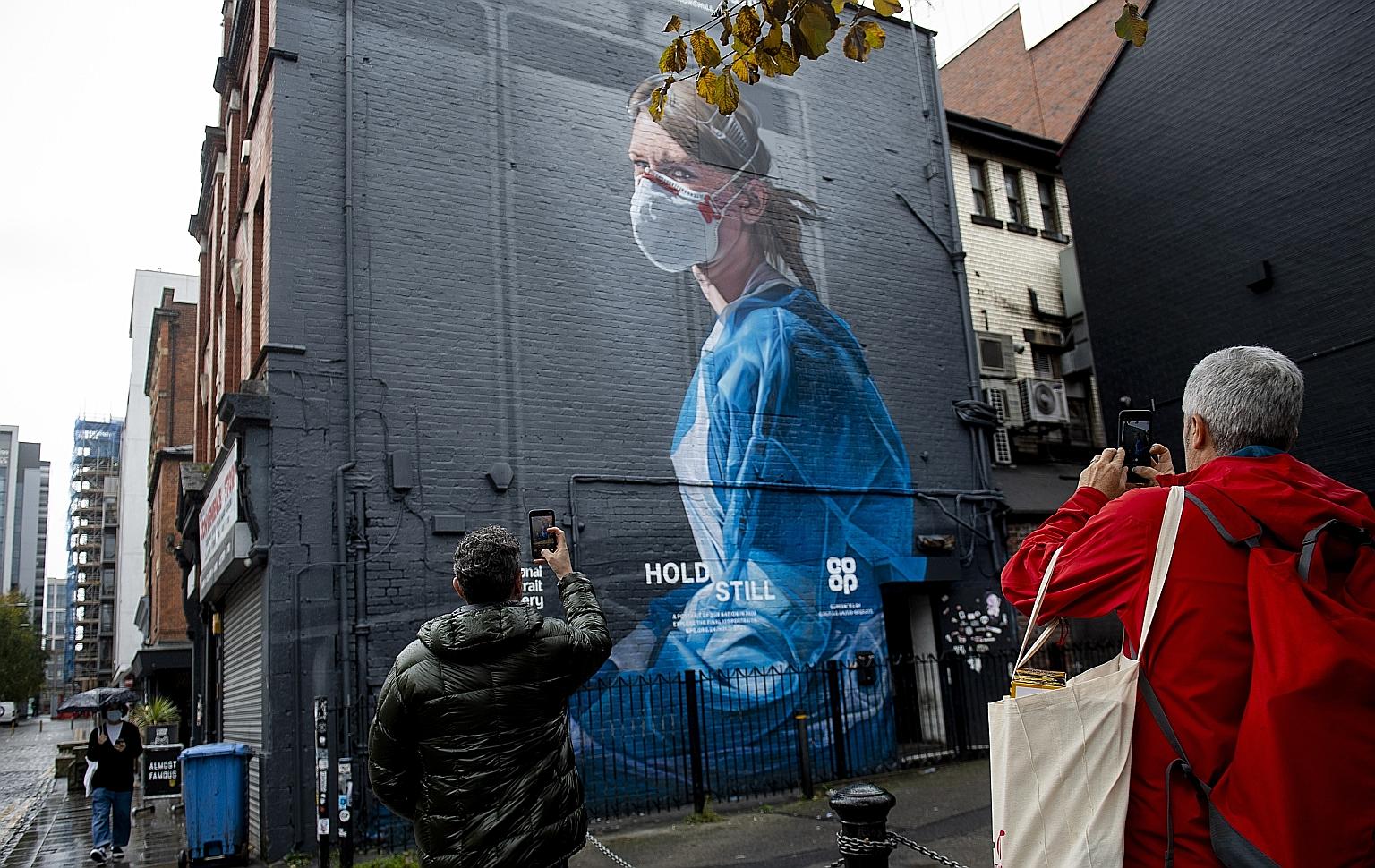 A mural depicting National Health Service nurse Melanie Senior in Manchester's Northern Quarter. Britain is swamped by a second wave of Covid-19 infections that could pose an even bigger test than the first wave for its overextended health service.