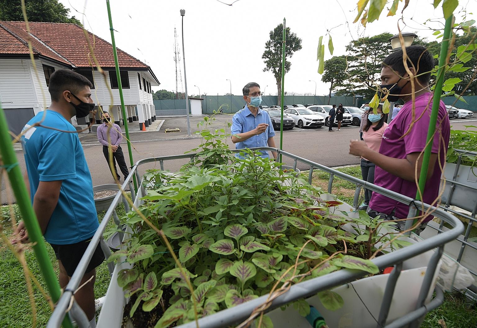 Minister of State for Home Affairs and National Development Muhammad Faishal Ibrahim (centre) with two residents at the Community Rehabilitation Centre yesterday. ST PHOTO: ALPHONSUS CHERN