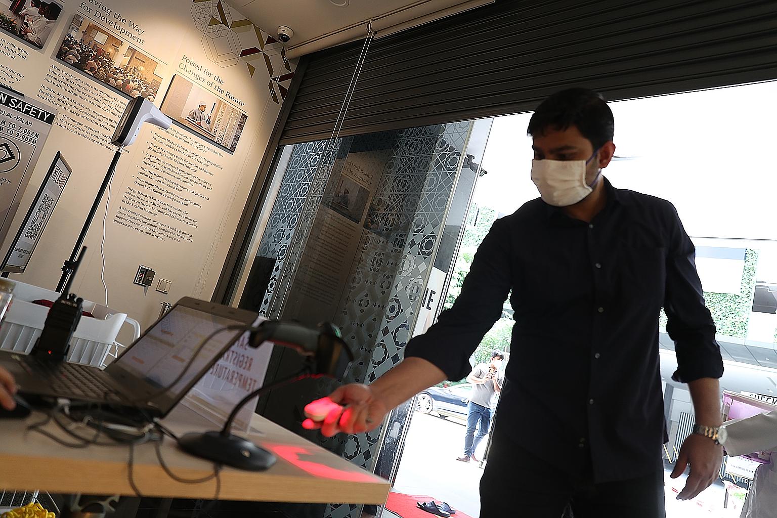 A congregant using the TraceTogether token to check in at Masjid Al-Falah yesterday. The mosque has introduced a green lane that allows those using the TraceTogether app or token to gain entry more quickly.