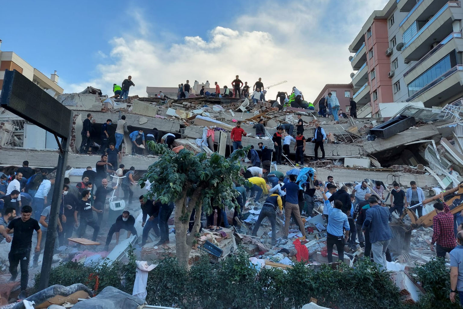 Rescuers searching for survivors of a collapsed building in Izmir, Turkey, after a strong earthquake struck the Aegean Sea yesterday. At least six people were killed and over 200 injured when the 7.0-magnitude temblor sent buildings crashing down and