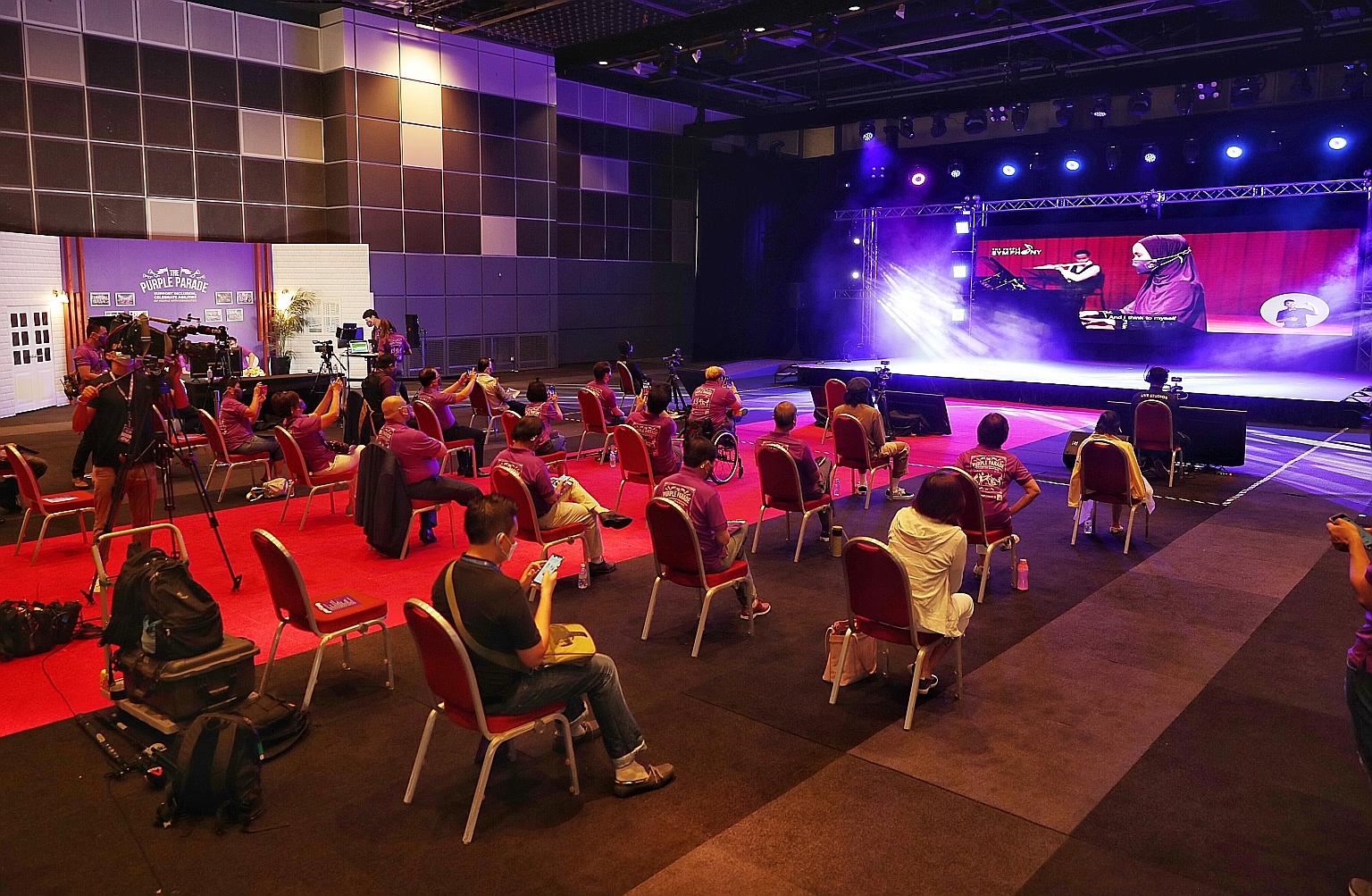 A performance by The Purple Symphony at a special screening of the Purple Parade at Suntec Singapore Convention and Exhibition Centre yesterday. On screen is pianist Siti Sakinah Zainal.