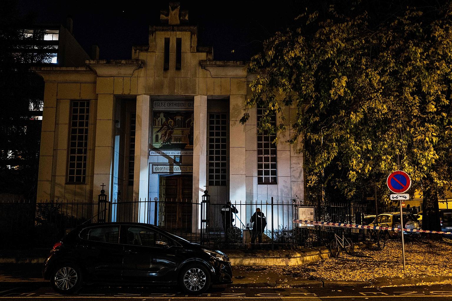 Police officers examining the entrance of the church in Lyon where the shooting took place last Saturday. The victim, a Greek Orthodox priest, was wounded in the chest at point-blank range, according to sources close to the inquiry. PHOTO: AGENCE FRA