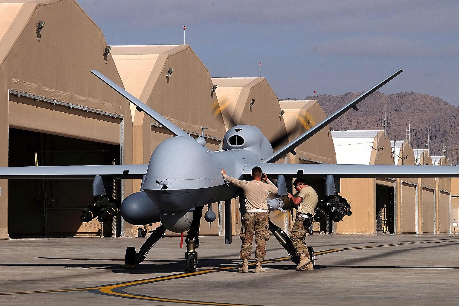 US airmen preparing an MQ-9 Reaper drone before it left on a mission, at Kandahar Air Field in Afghanistan in 2016. The US' agreement to sell such drones to Taiwan comes on the heel of several other major arms packages to the island announced in rece