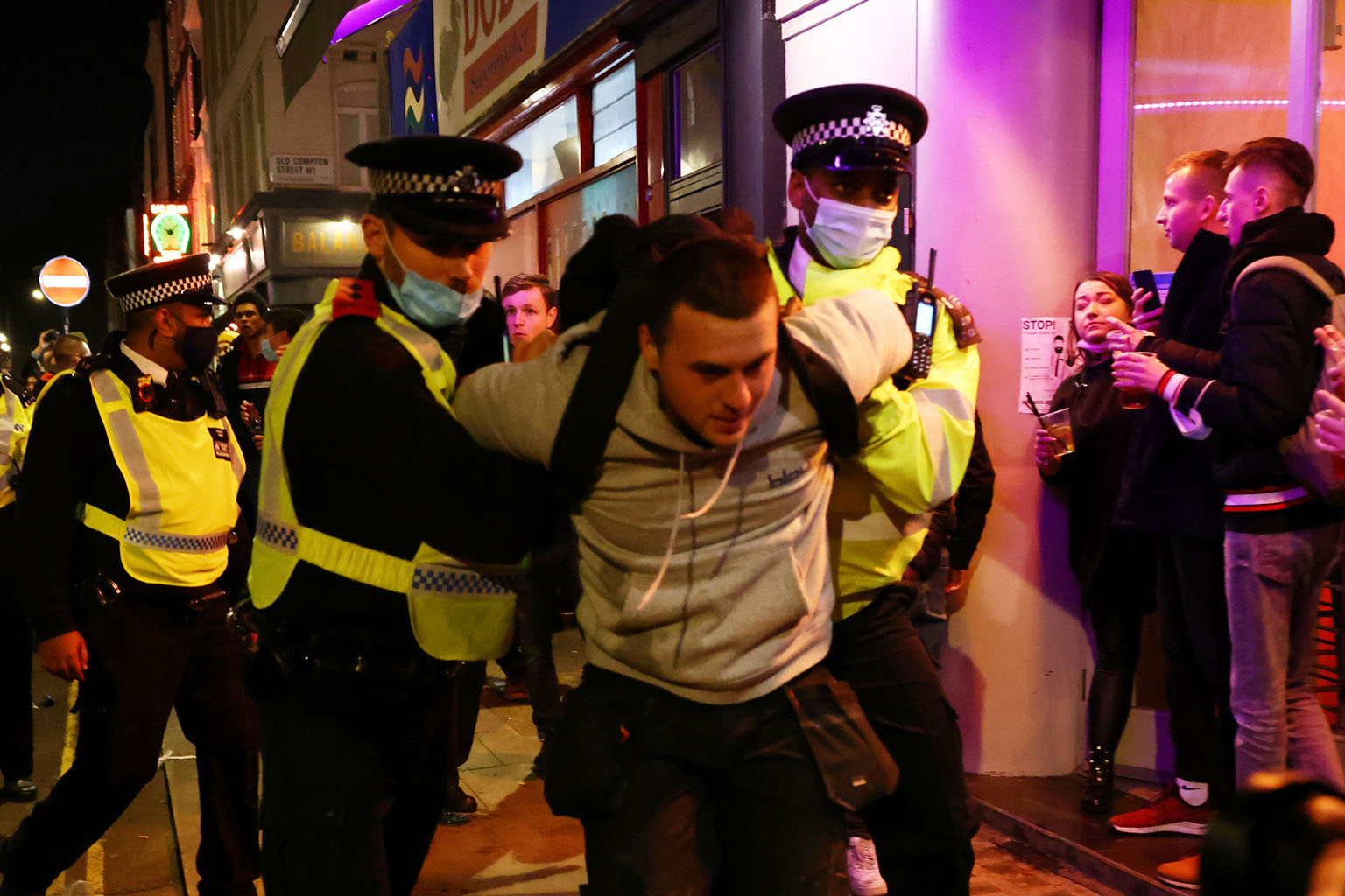 A man being arrested by police officers on Wednesday as pubs closed ahead of the lockdown in Soho, London. The month-long nationwide lockdown came into force on Thursday as cases began to spiral in all parts of England. PHOTO: REUTERS
