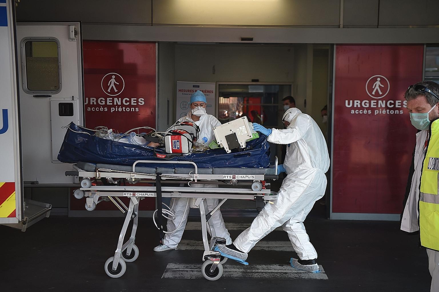 Medical staff transporting a Covid-19 patient to the emergency unit of a hospital in Strasbourg in eastern France last Friday. France is recording 54,440 cases a day on the latest seven-day average, Reuters data shows.