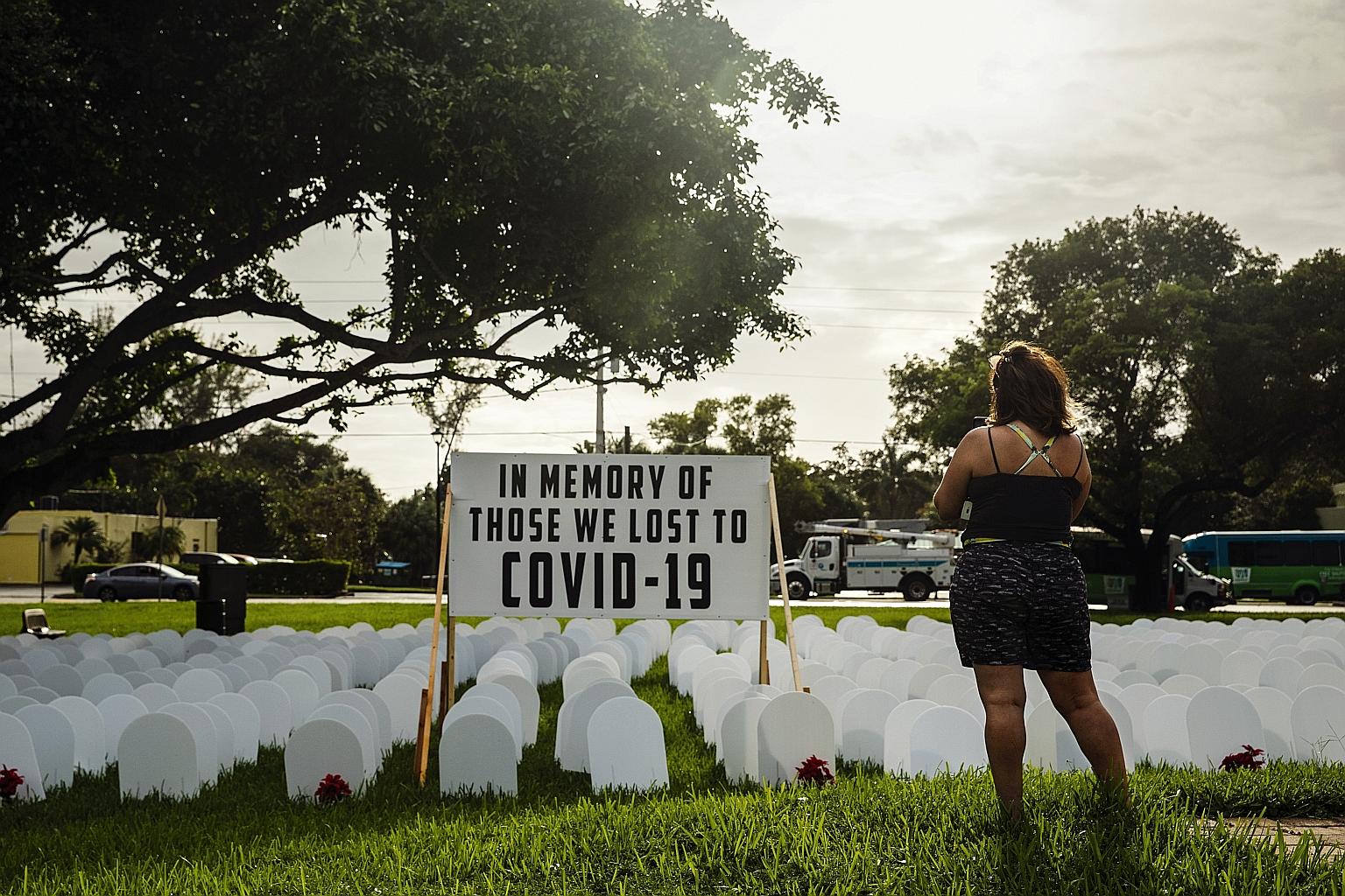 Mock tombstones in a makeshift memorial to those who have died from Covid-19 in North Miami, Florida. More than 240,000 Americans have died of the disease since it first emerged in China late last year. The number of reported deaths in the US climbed