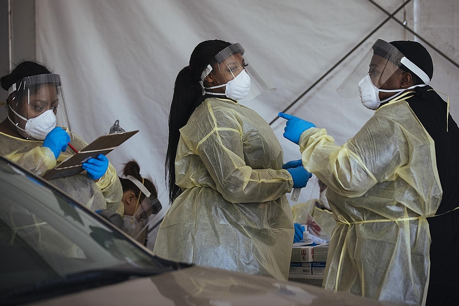 Workers at a drive-through coronavirus testing site in Milwaukee, Wisconsin, last week. The United States is battling a third wave of the virus.