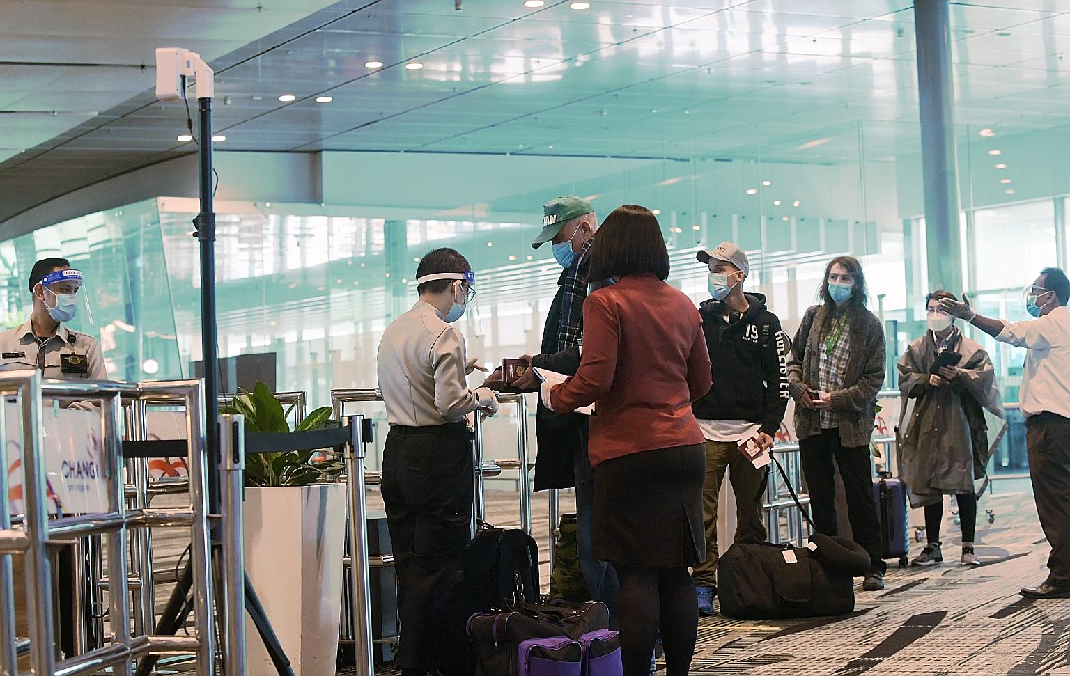 Travellers queueing to enter a transit holding area at Changi Airport. Education Minister Lawrence Wong said Singapore is keen on discussing air travel bubbles with places that have a similar Covid-19 incidence rate as Singapore, or are safe and low-
