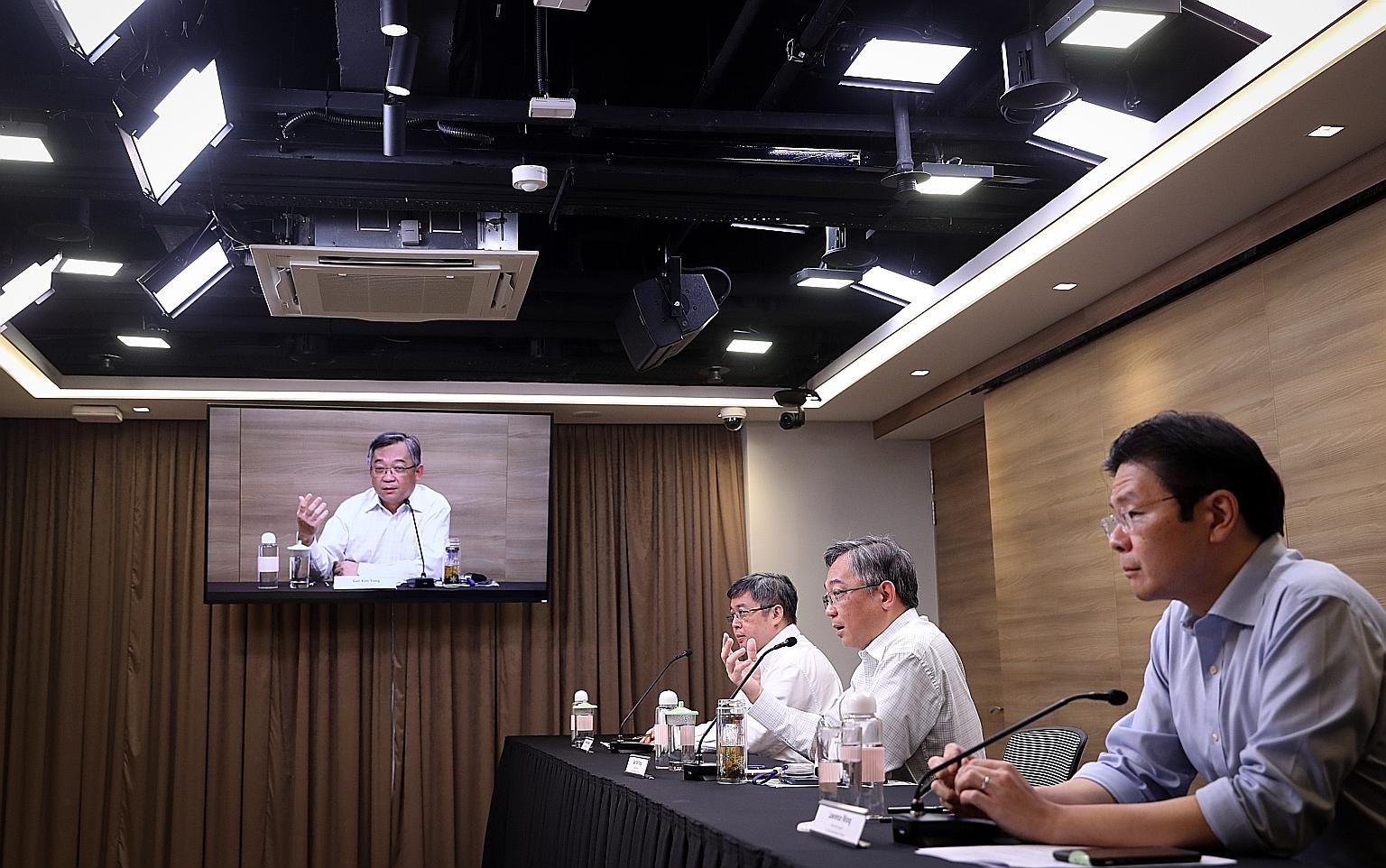 Health Minister Gan Kim Yong (centre), Education Minister Lawrence Wong (right) and Associate Professor Kenneth Mak at a briefing on the Covid-19 situation yesterday. Mr Gan said that even when vaccines become available, they will have to be given ou