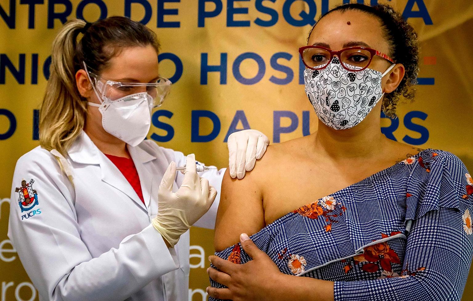Health worker and volunteer Fabiana Souza receiving a Covid-19 vaccine produced by Chinese company Sinovac at the Sao Lucas Hospital in Porto Alegre, southern Brazil, on Aug 8.