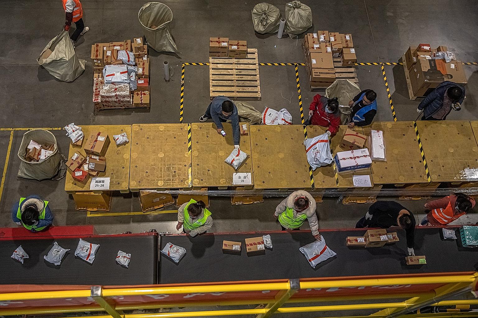 Workers sorting packages at an automated logistics centre for Chinese e-commerce giant JD.com on Singles' Day in Beijing yesterday.