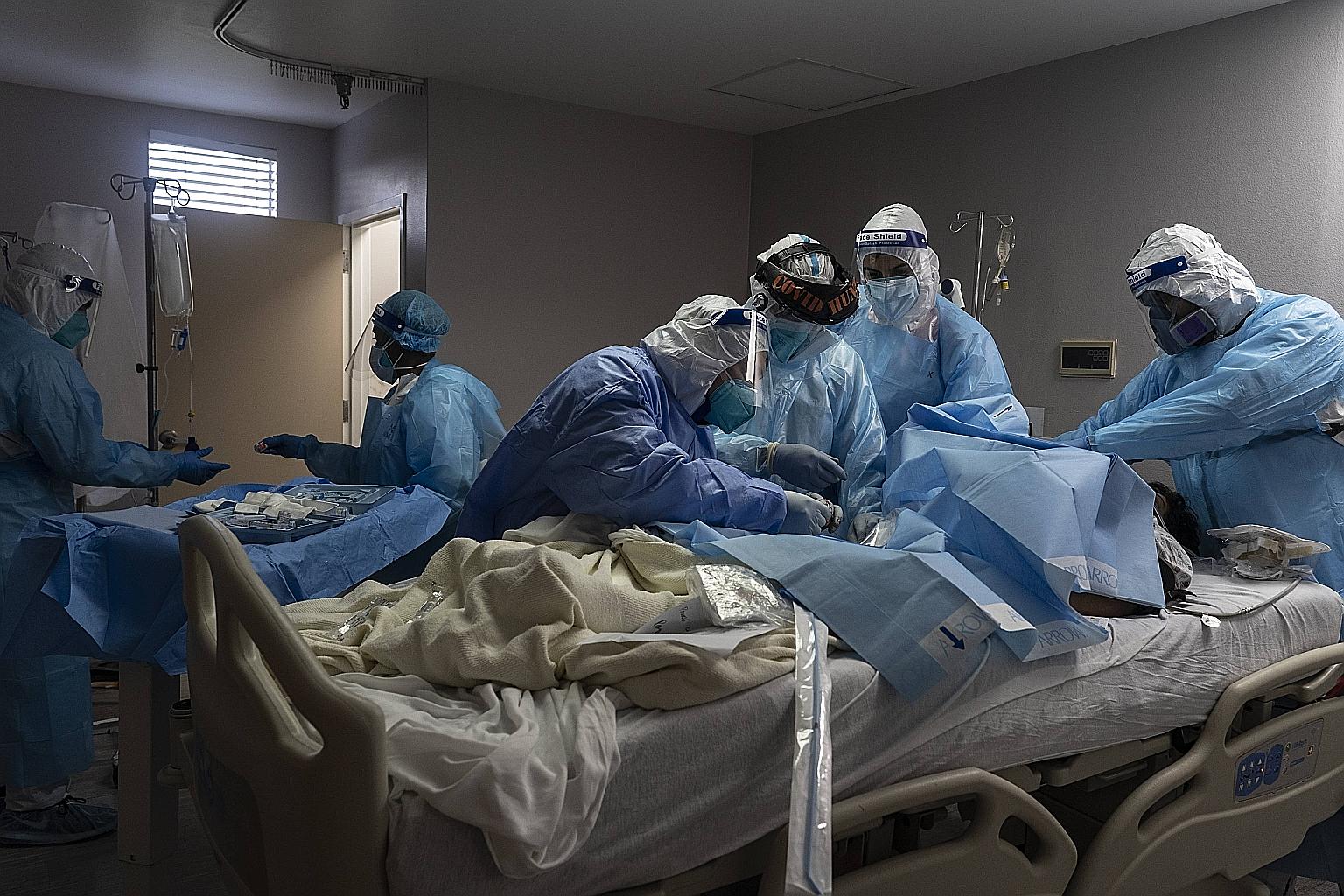 Medical staff treating a patient with Covid-19 in the intensive care unit at the United Memorial Medical Centre in Houston, Texas, on Tuesday. The number of cases in Texas has exceeded one million.