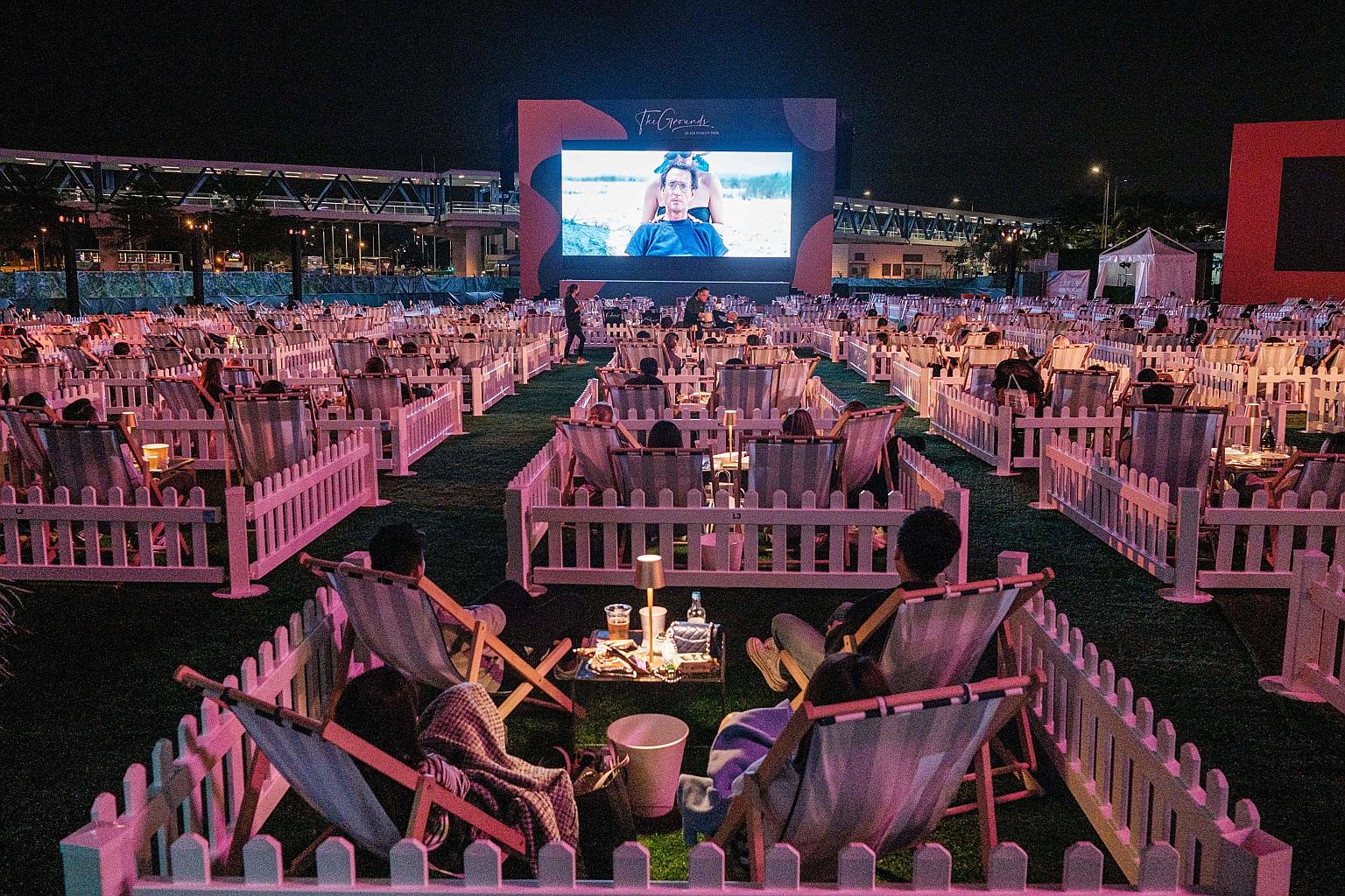 People watching a film at Hong Kong's first socially distanced outdoor entertainment venue, which has 100 private "pods" that can accommodate two to four people. Tickets for one-way direct flights from Singapore to Hong Kong by Singapore Airlines and