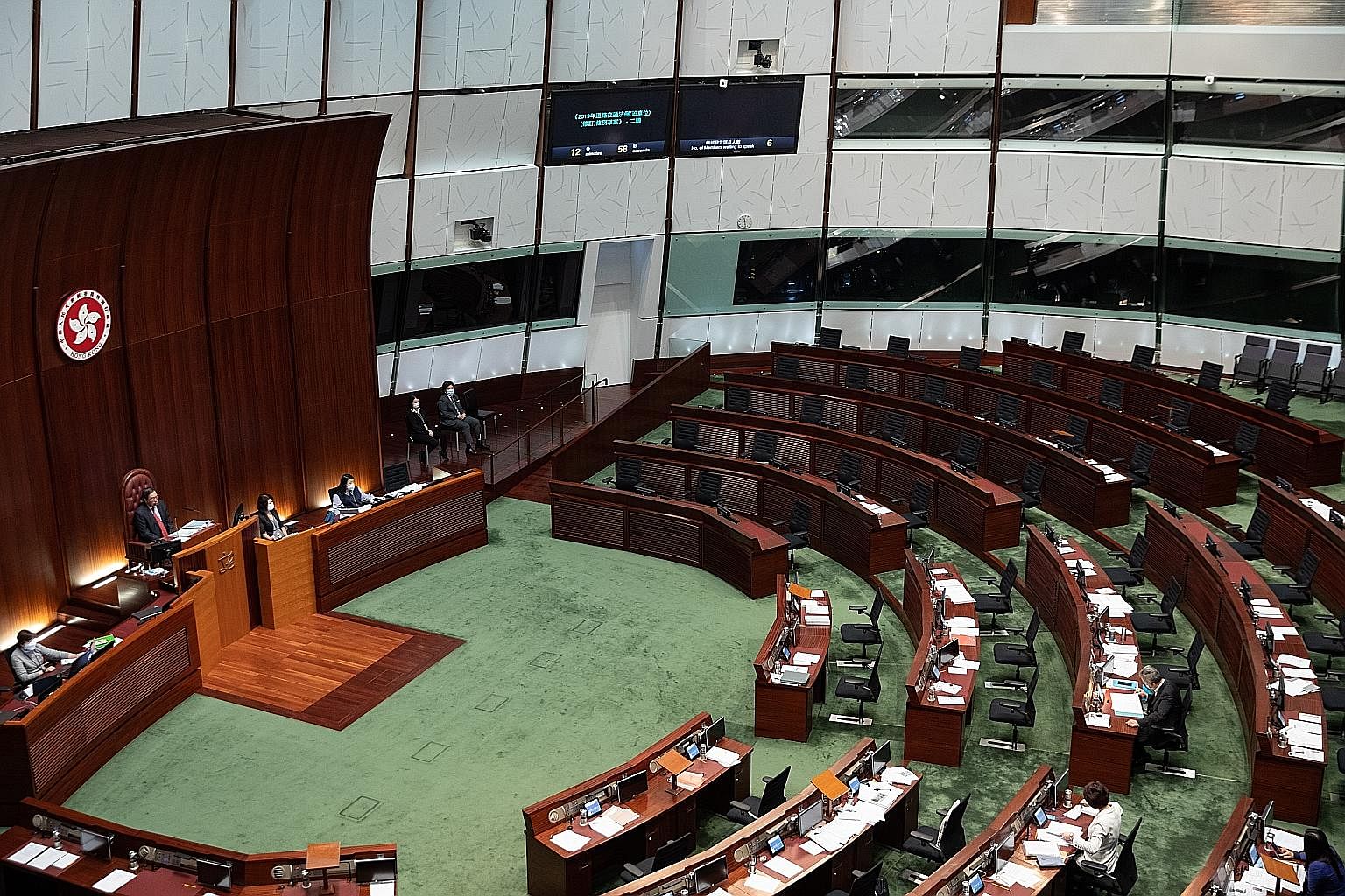 Hong Kong's legislature sat empty of pro-democracy lawmakers yesterday after the bloc resigned en masse in protest at the city's pro-Beijing government banning four of their colleagues from holding office. China labelled the resignations a "blatant c