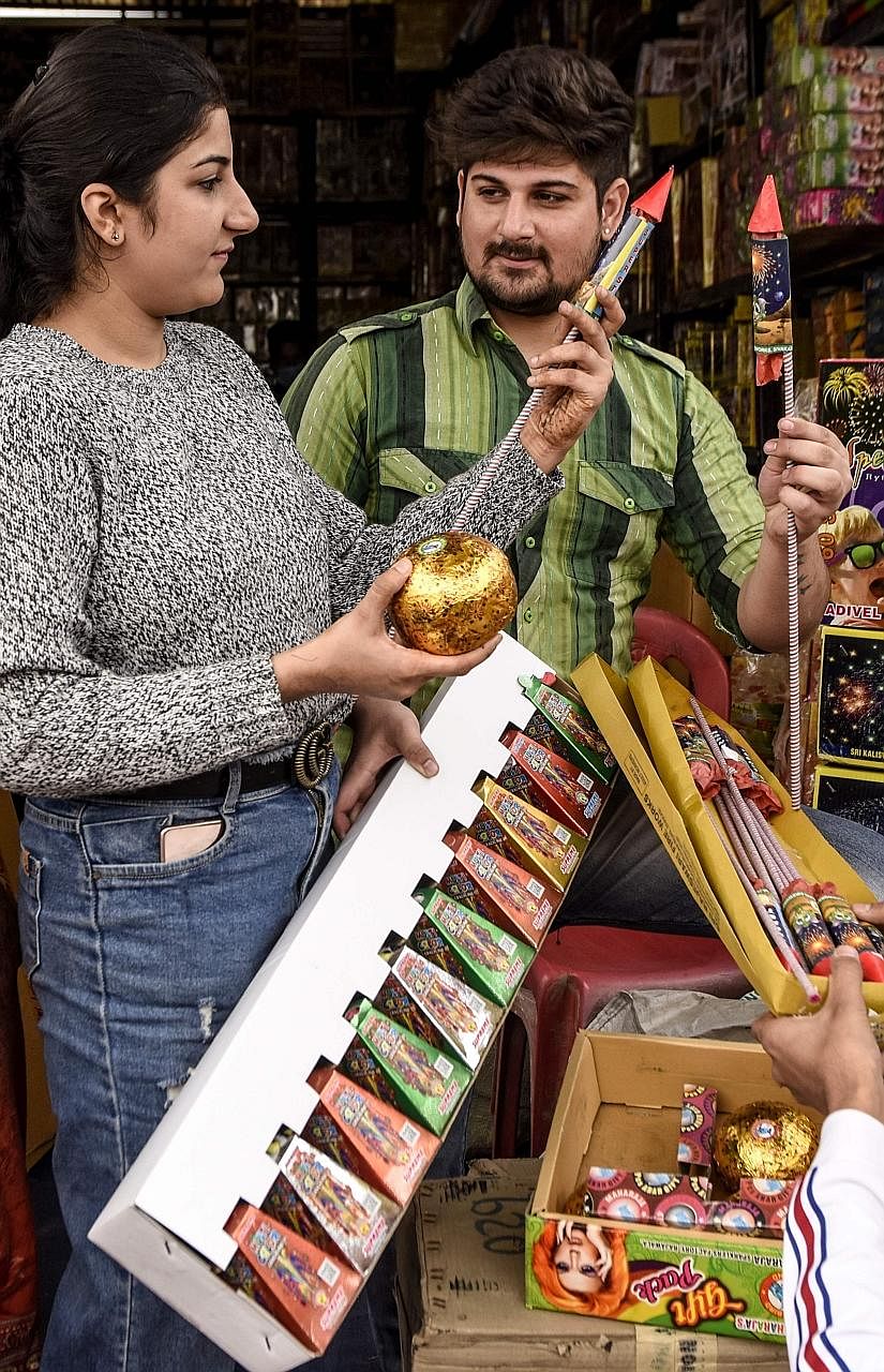 Indians buying firecrackers ahead of Deepavali yesterday. Fearing that the air pollution from firecrackers will worsen the pandemic, several states have restricted or banned their sale and use.