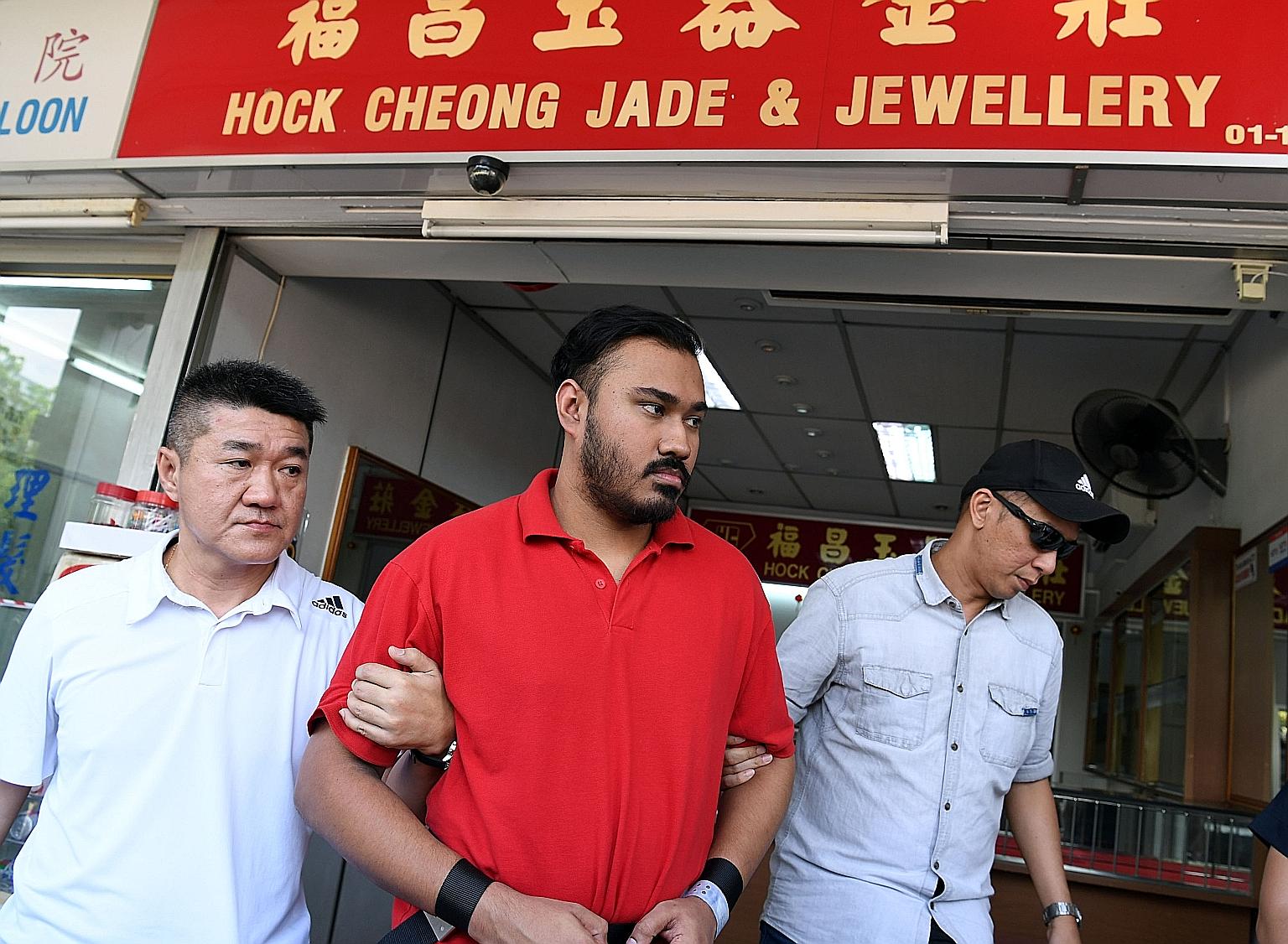 M. Jegatheesh was brought back to Hock Cheong Jade and Jewellery shop by the police on Aug 21 last year. He was jailed for three years and three months and sentenced to six strokes of the cane yesterday for his role in the robbery on Aug 14 last year