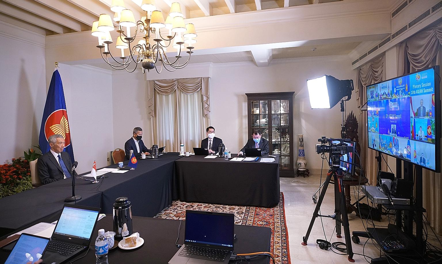 Prime Minister Lee Hsien Loong and Foreign Minister Vivian Balakrishnan (second from left) attending the Asean Summit via videoconference yesterday. As nations look towards the next stage of recovery, PM Lee said they must work together in the area o