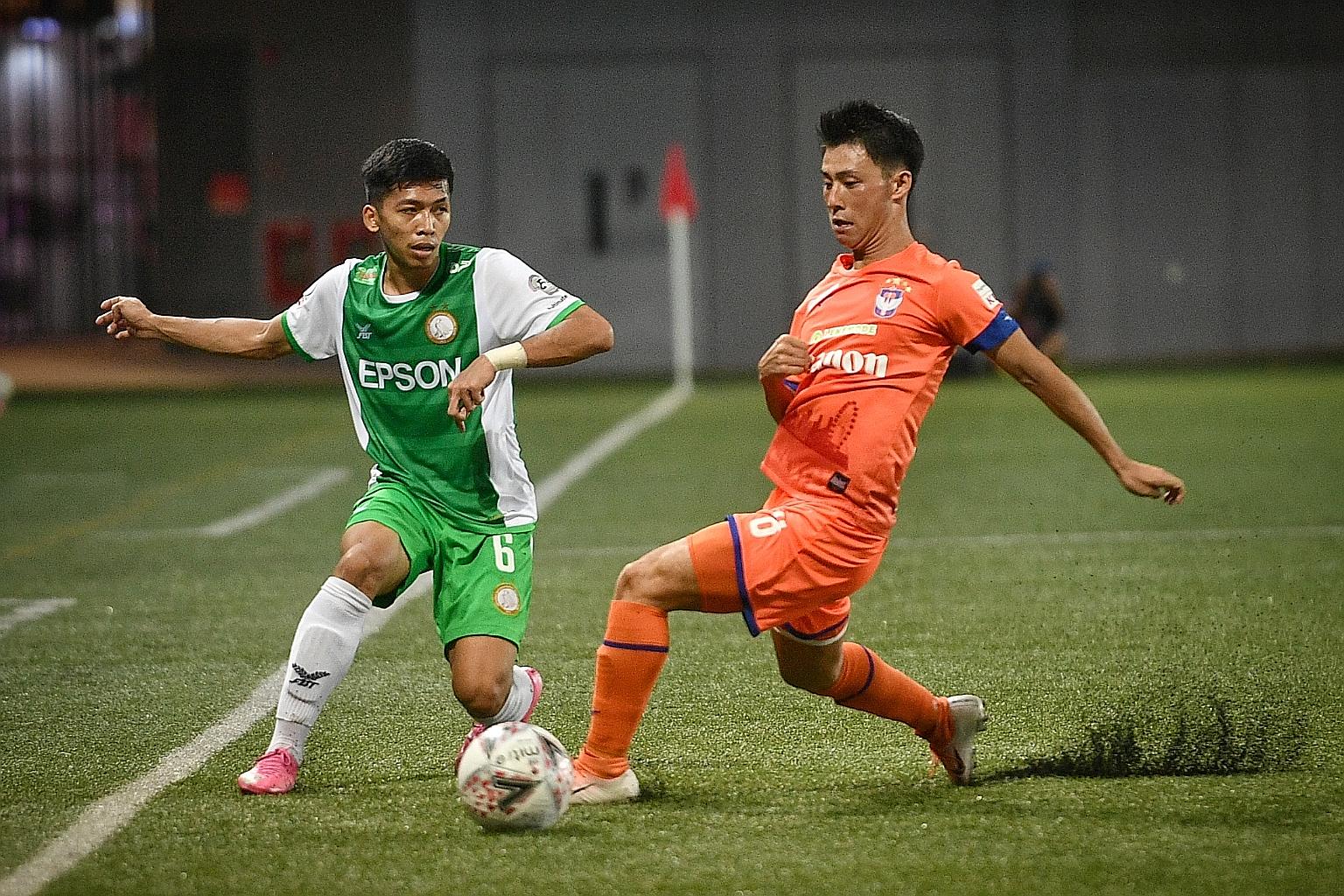 Albirex Niigata's Hiroyoshi Kamala challenging Geylang International's Nur Luqman Rahman during their SPL match at Our Tampines Hub last night. Albirex won 1-0 through Tomoyuki Doi's third-minute free kick.