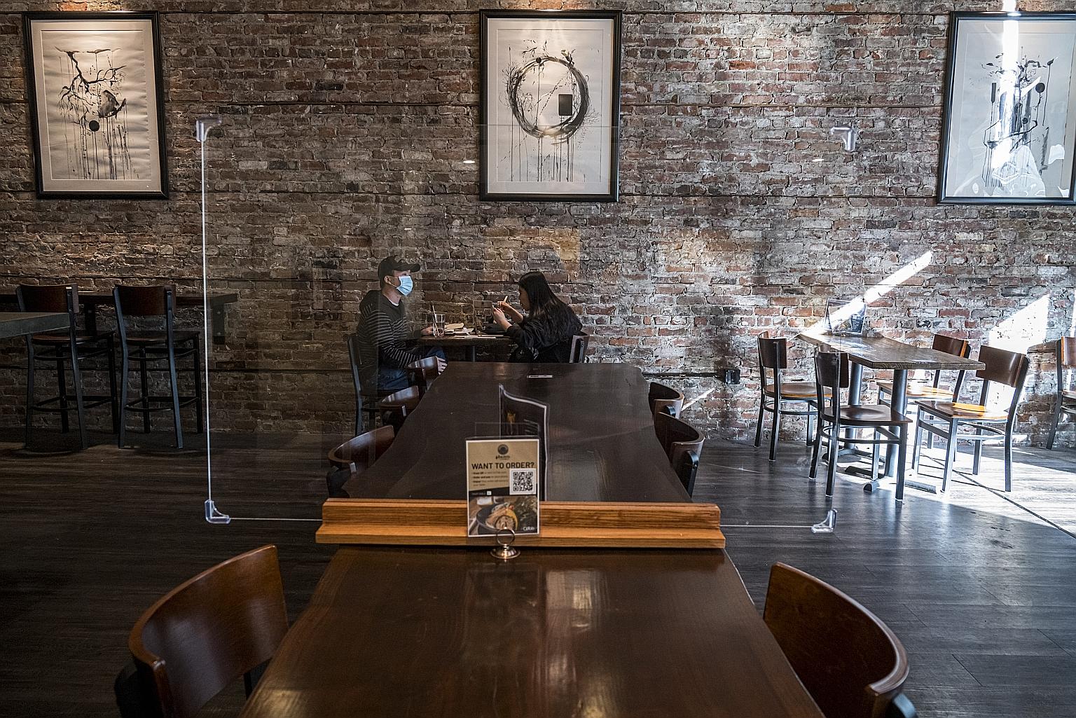 Customers at a restaurant in San Francisco, California, on Thursday. With much of the United States and Europe enveloped in a new wave of coronavirus outbreaks, Bank of England governor Andrew Bailey and European Central Bank president Christine Laga