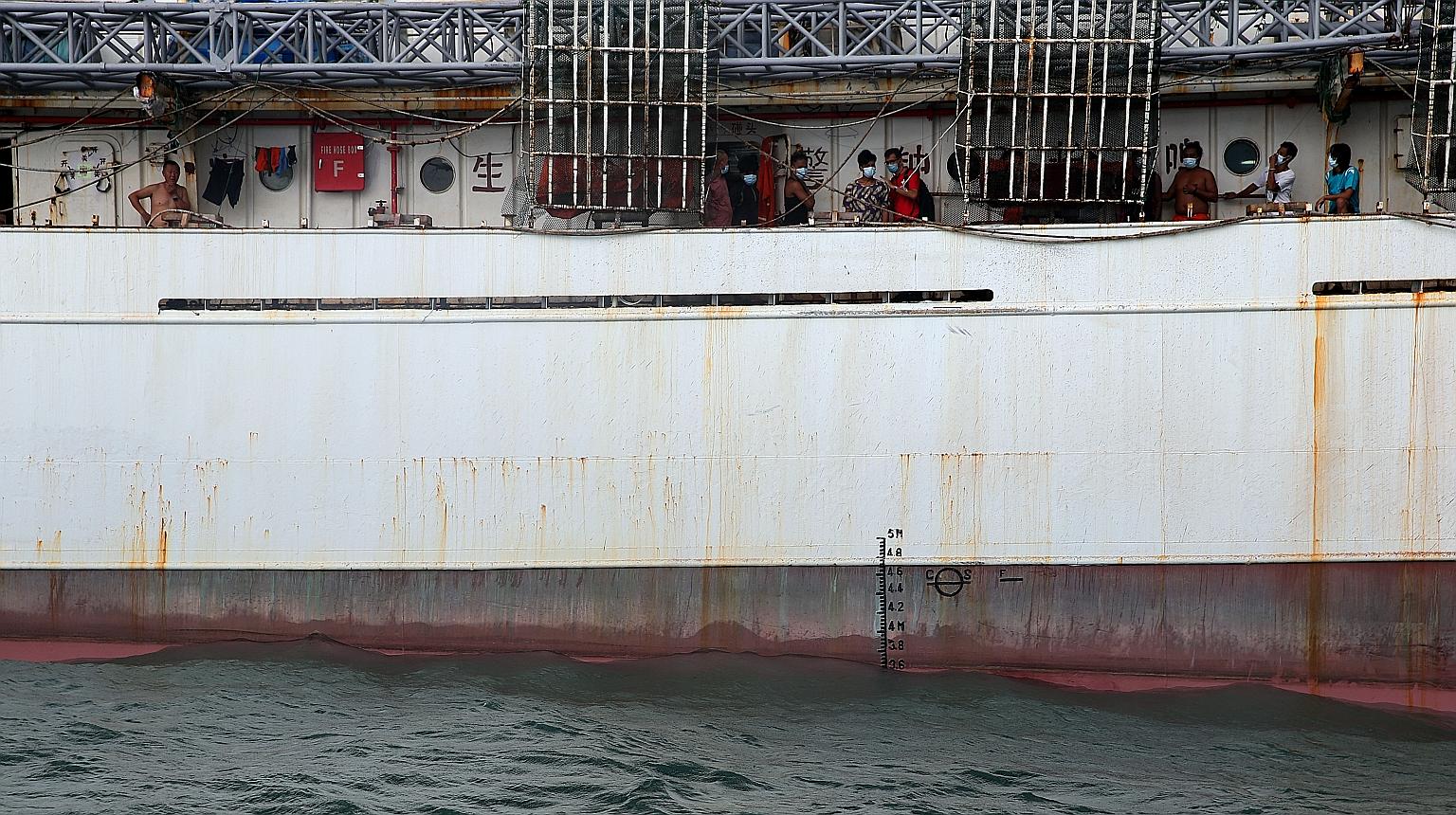 Filipino seamen on board a 22,000-tonne tanker. More than 400,000 seafarers around the world have had to remain on board their ships for about a year or longer because of the coronavirus pandemic. Singapore doctor Charles Johnson (in red T-shirt), me